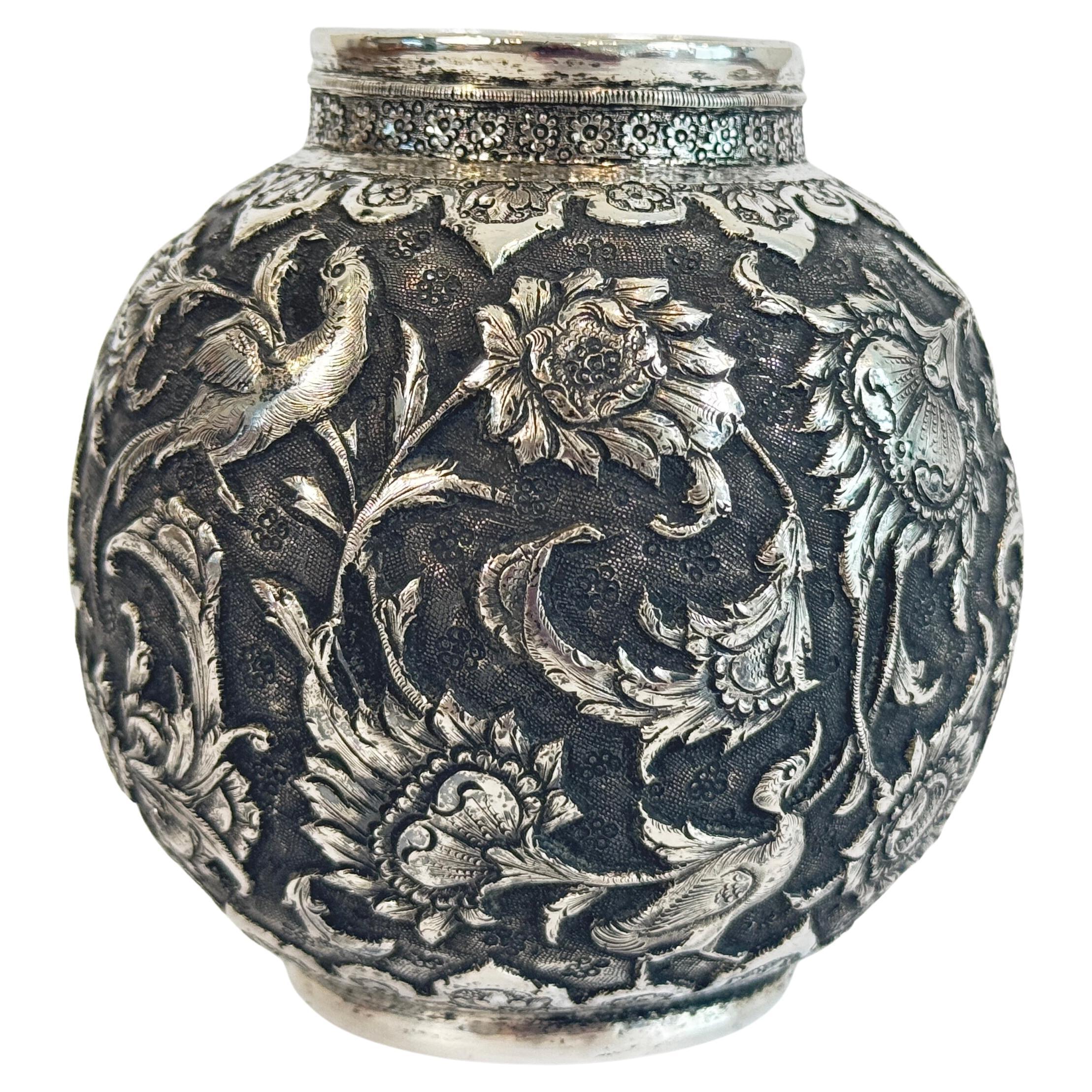 Persian Silver Repousse Decorated Vase, of petite form, chased in relief with an all over pattern of birds amidst scrolling foliage, the base with signature and two indistinct, partially rubbed hallmarks. A perfect decorative addition to an