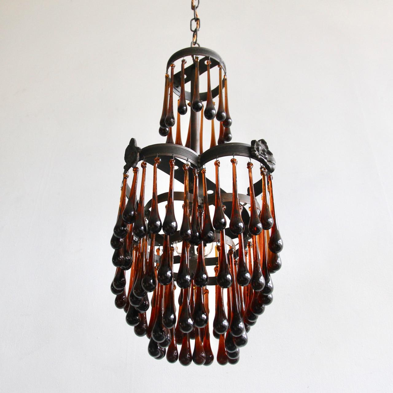 Small petal waterfall chandelier dressed in striking oversized brown glass teardrops. This light would provide a bold injection of colour as it is still impactful even when unlit, its single lamp is concealed and will glow through the teardrops.
 