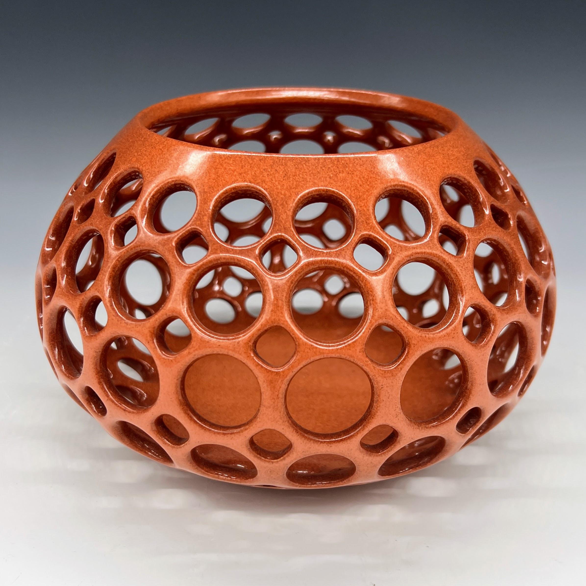 Inspired by Mid-Century Modern design, this piece is wheel thrown and hand pierced stoneware with a satin glaze. Small holes are created when the clay is still wet and then each hole is painstakingly enlarged and smoothed when the clay is bone dry.