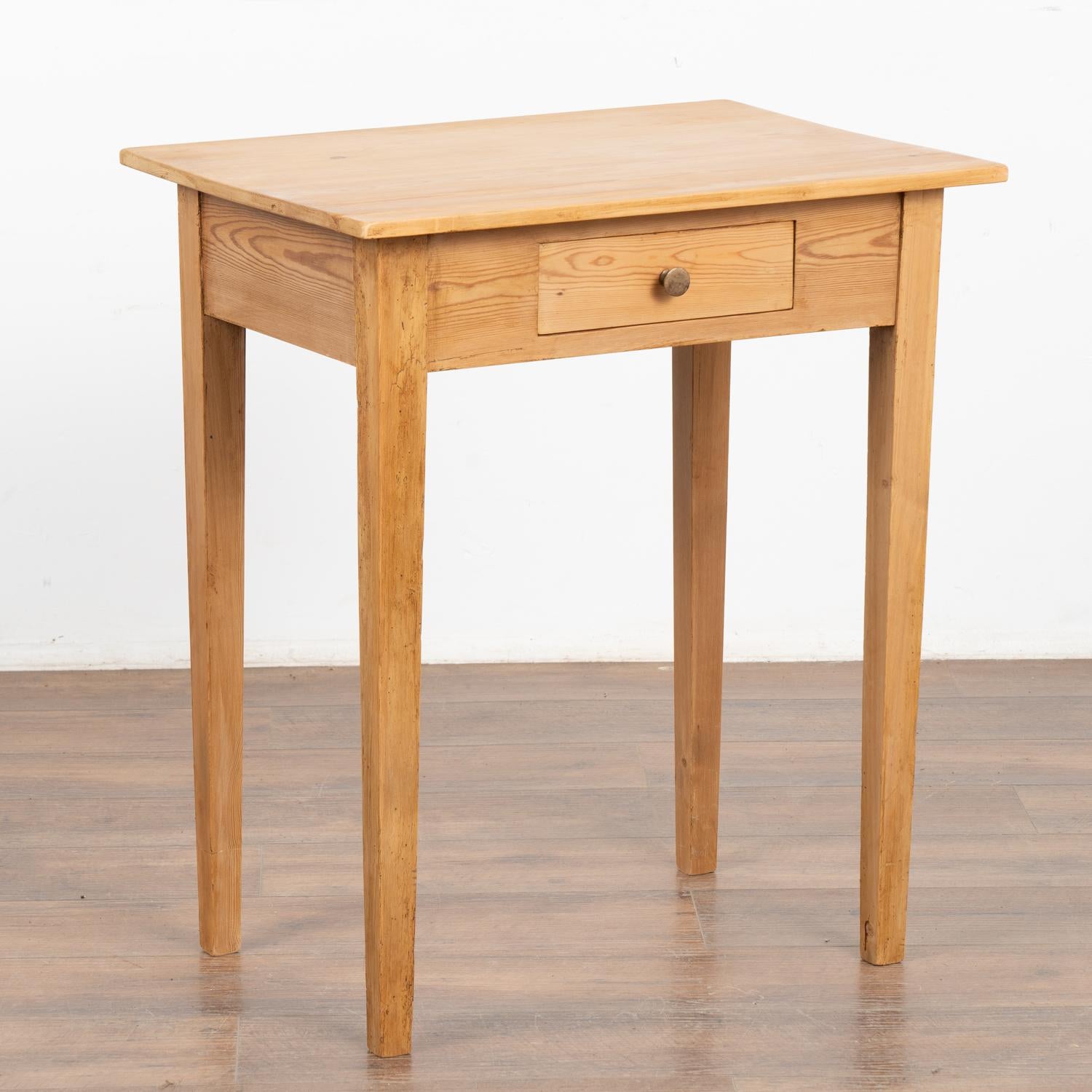 This delightful country pine table with single drawer stands on tapered legs and will make a casual side table or nightstand. 
This table has been restored, the drawer function with brass pull and it is ready to be used and enjoyed.
All scratches,