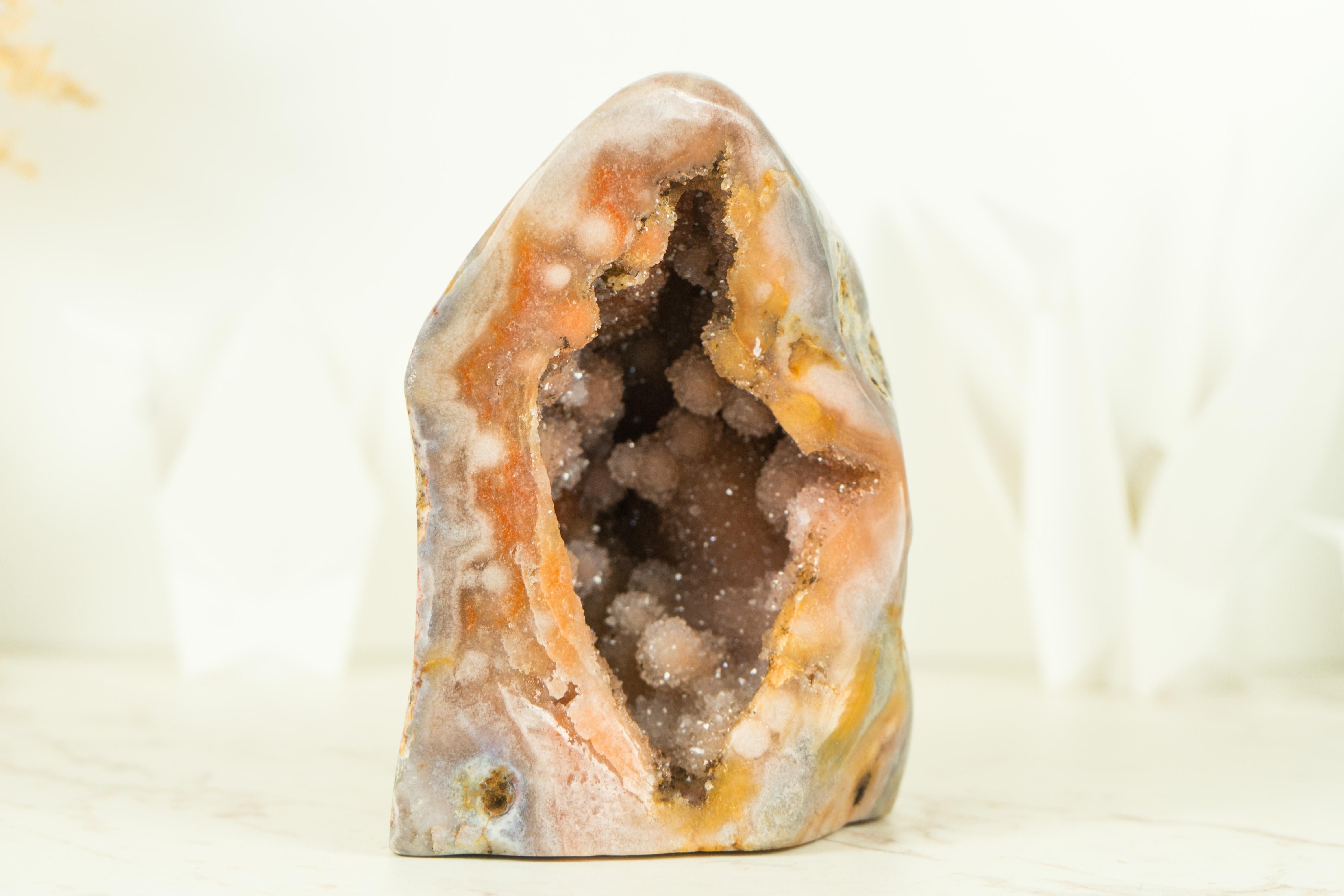 A stunning small self-standing Pink Amethyst geode, featuring a naturally formed sculpture with shiny Galaxy Pink Amethyst Druzy that will bring a sense of calm, harmony, and positivity into your home or office decor with its soothing and gentle