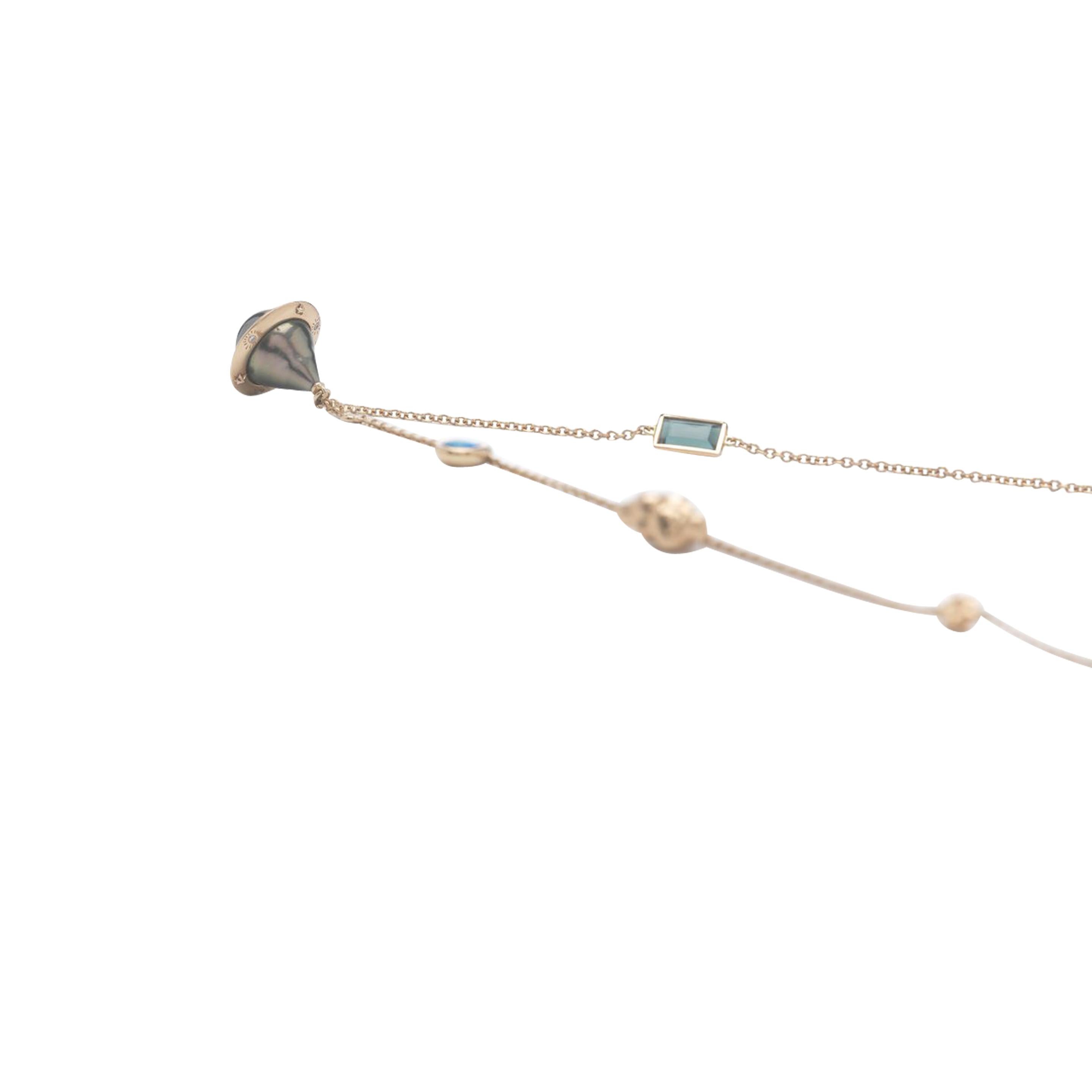 Designed as a delicate chain that sits on the collarbone, the Small Planet Necklace is fashioned in 18k rose gold, with small charms set along its length. One is a Tahitian pearl planet that sits alongside a tourmaline, an opal bead and a 18k rose