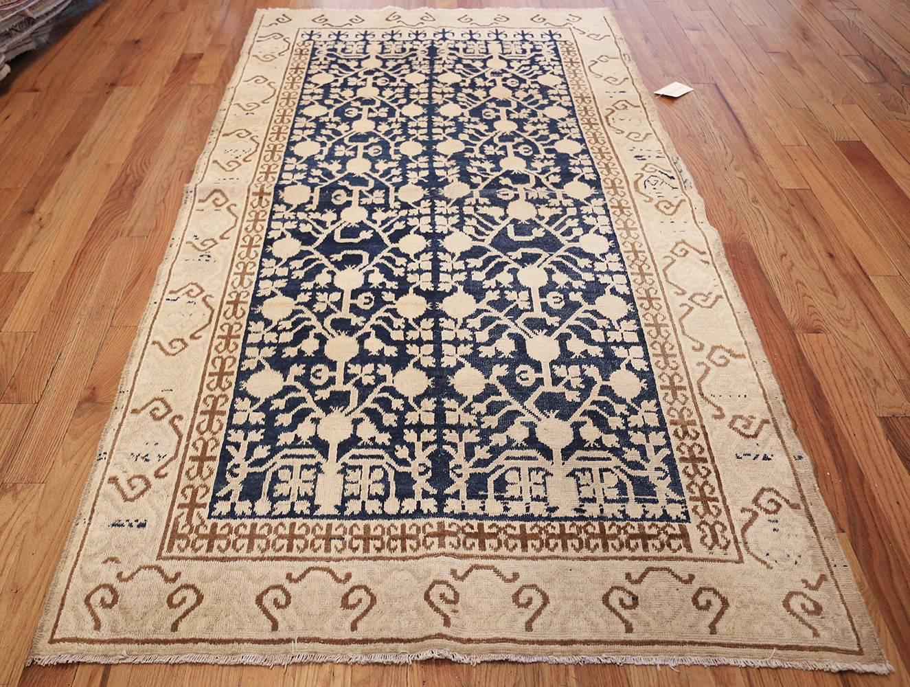 Beautiful Light Blue Small size Pomegranate Design Antique Khotan Rug, Country of Origin: East Turkestan, Circa Date: Early 20th Century. Size: 4 ft 6 in x 8 ft 3 in (1.37 m x 2.51 m)

This elegantly understated antique Khotan rug, from East