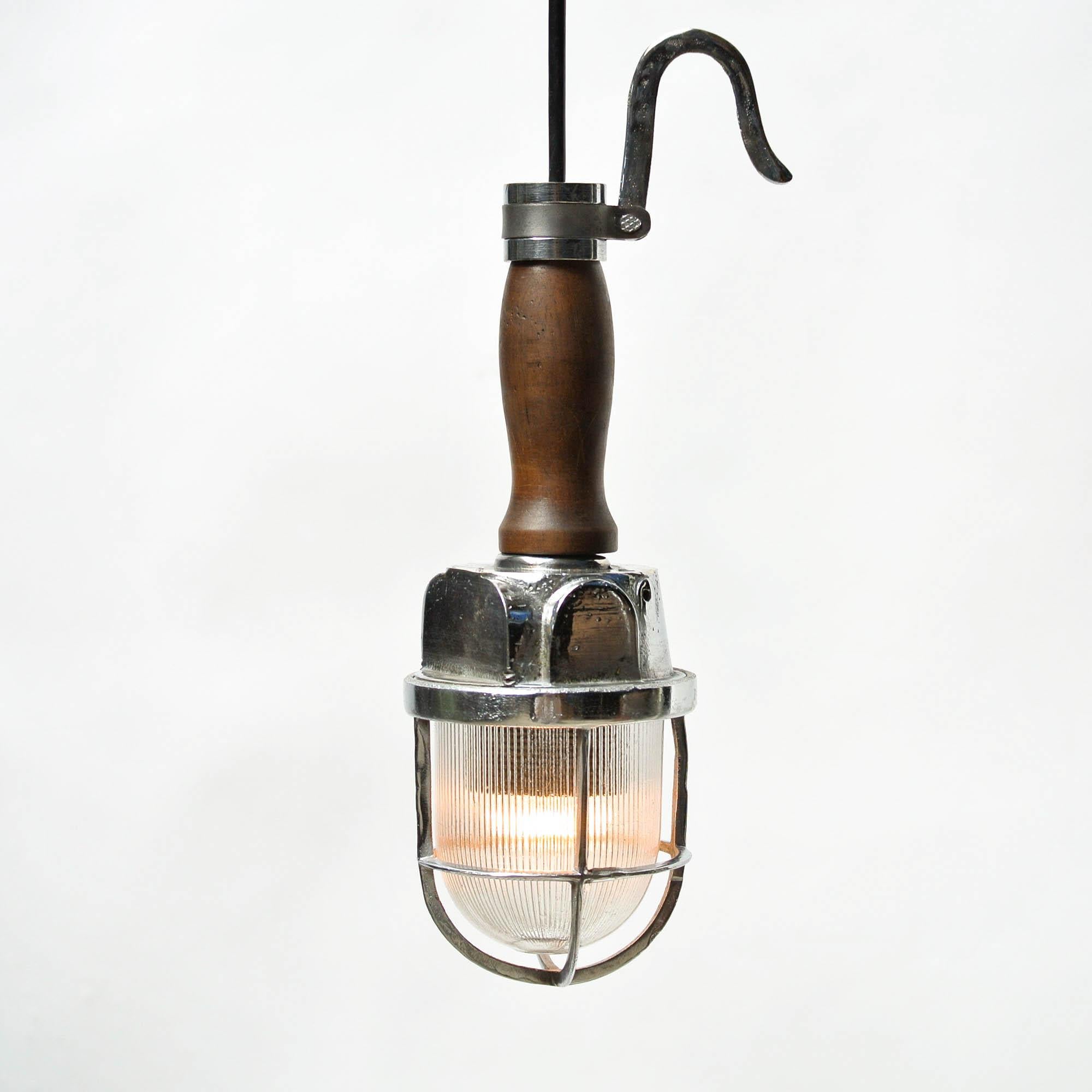 Very pretty vintage portable lamp, corrugated glass protected by a fence made of chromed brass. waxed wood handle. Perfect for a small point of light. Can be used as a ceiling lamp or hanged.

 