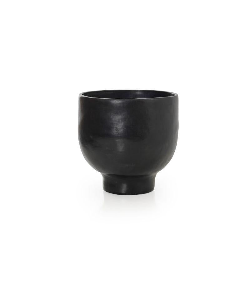 Small pot 1 by Sebastian Herkner
Materials: Heat-resistant black ceramic. 
Technique: Glazed. Oven cooked and polished with semi-precious stones. 
Dimensions: Diameter 30 cm x height 30 cm 
Available in sizes large and mini.

This pot belongs
