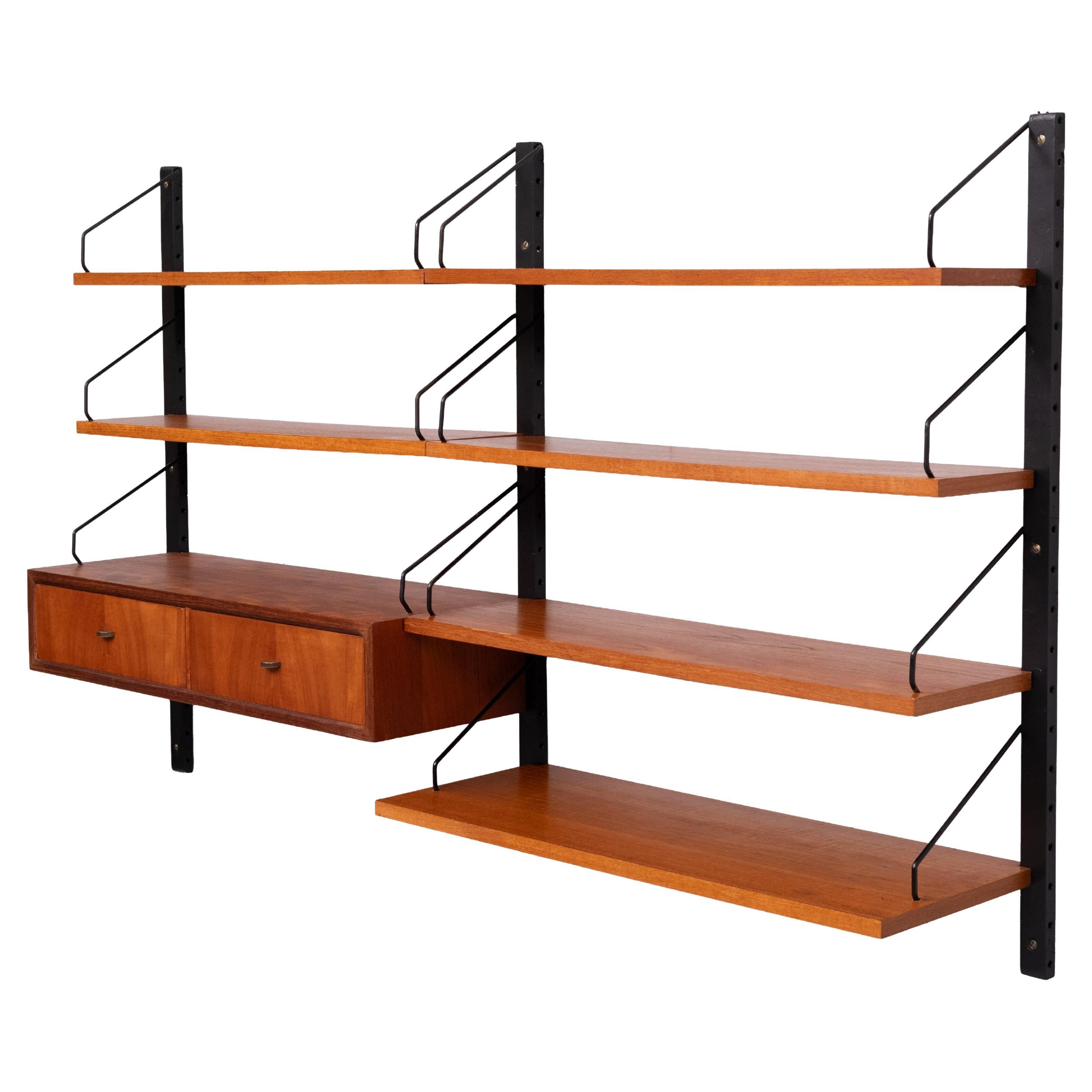 Very nice modular wall system .consisting of .Three black 
uprights .Seven Teak shelves . in Two sizes . One hanging Cabinet 
comes with Two drawers .With solid Brass handles .complete with 
all the brackets . Design by Poul Cadovius for Royal