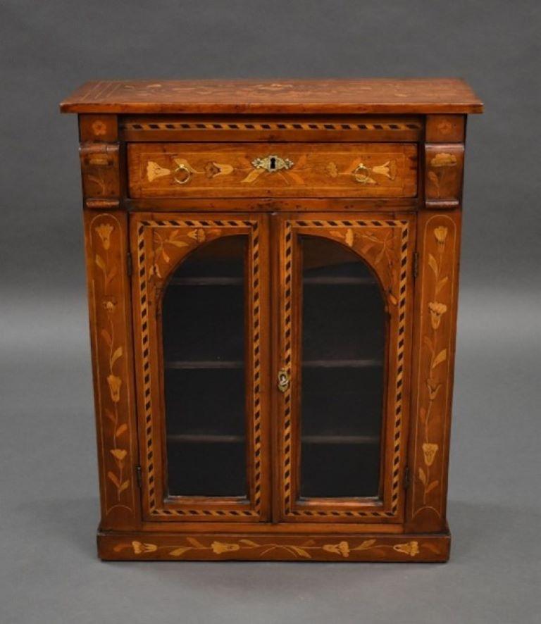 Small Proportioned 19th century Dutch marquetry cabinet profusely inlaid and having two glazed doors above a plinth base. The cabinet remains in very good condition for its age.