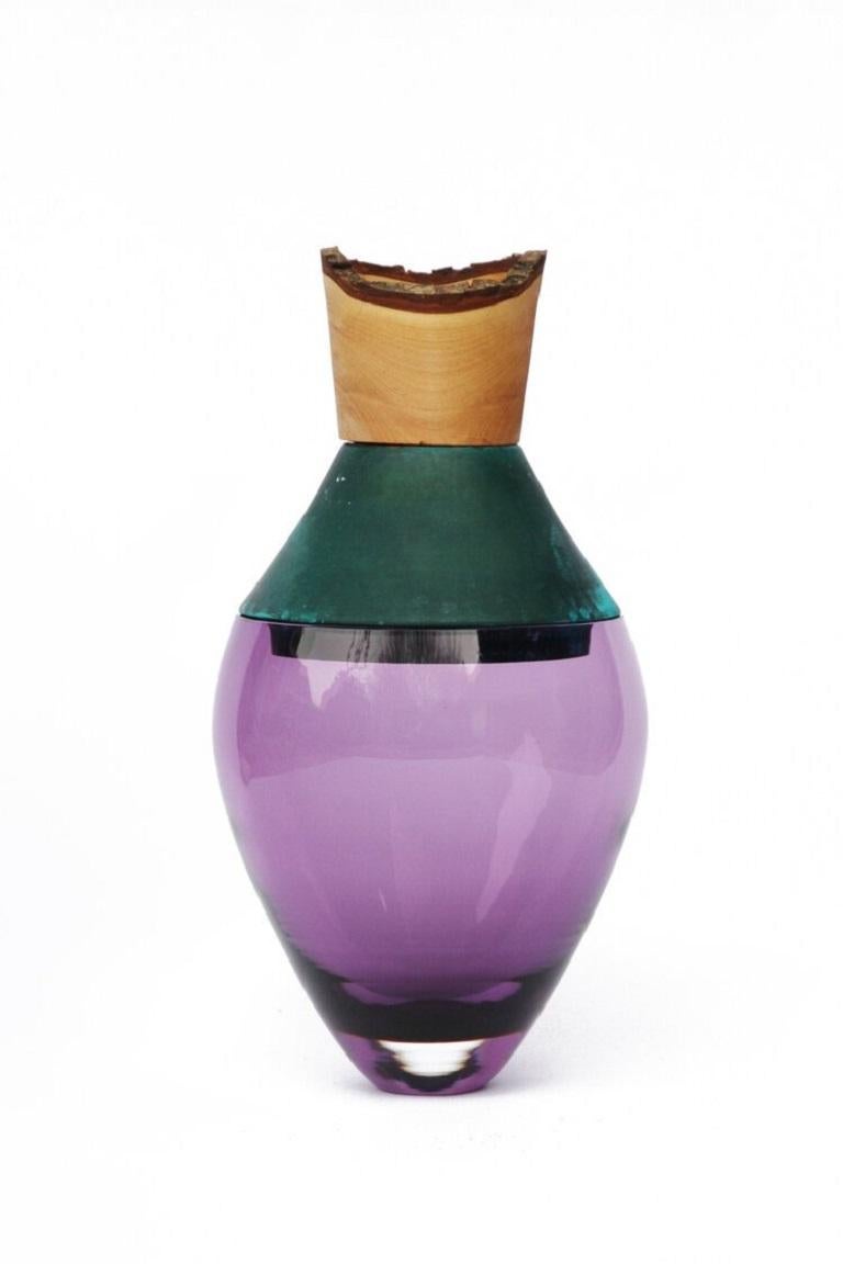 Small purple and copper patina India vessel I, Pia Wüstenberg.
Dimensions: D 15 x H 30.
Materials: glass, wood, copper patina.
Available in other metals: brass, copper, brass patina, copper patina, rust

Handmade in Europe, by individual