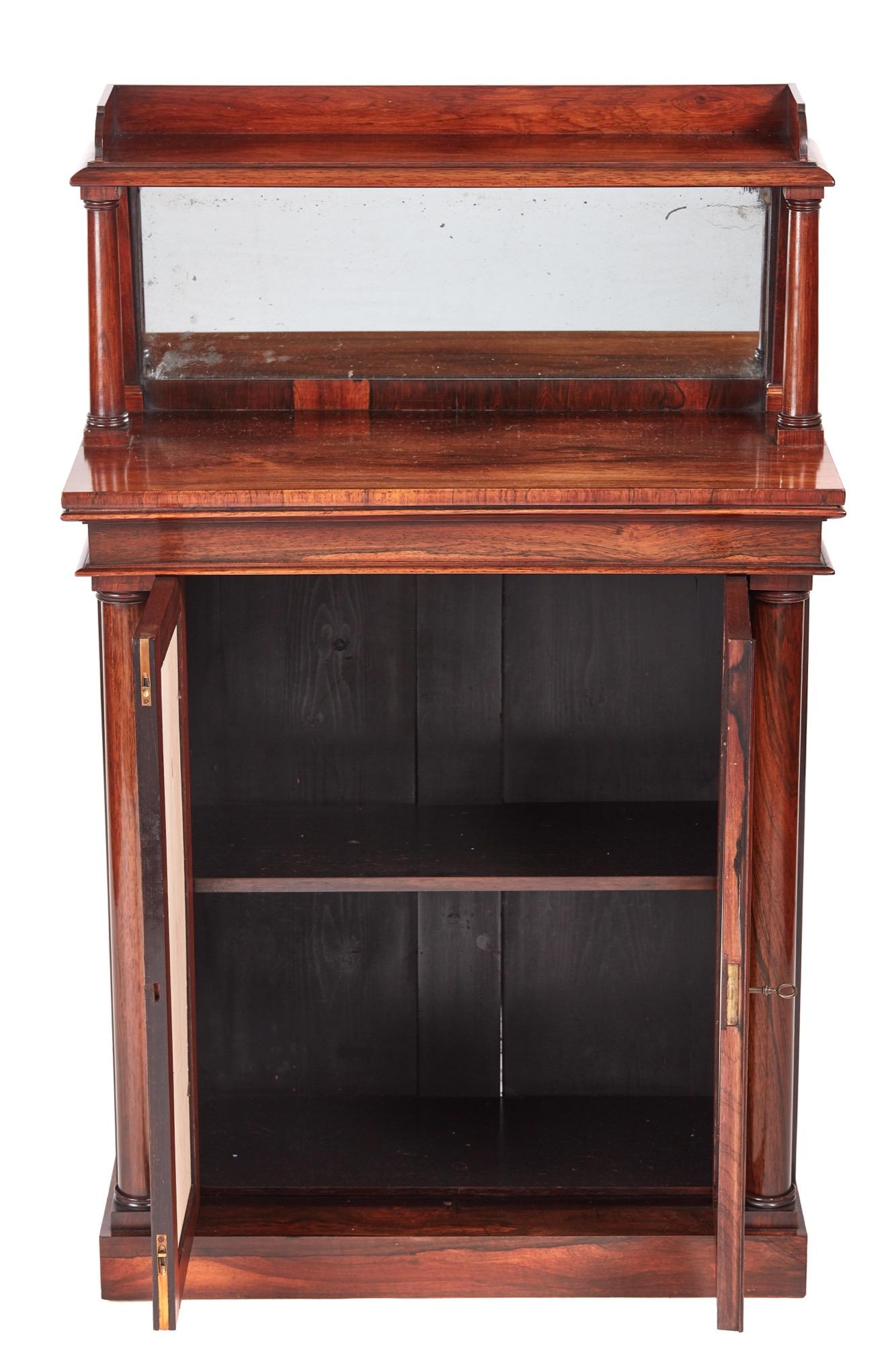 Small quality antique William IV rosewood chiffonier with a rosewood mirror back. It is supported by two solid rosewood columns and has a delightful quality rosewood top. Two mirrored doors with one shelf interior and two elegant solid rosewood