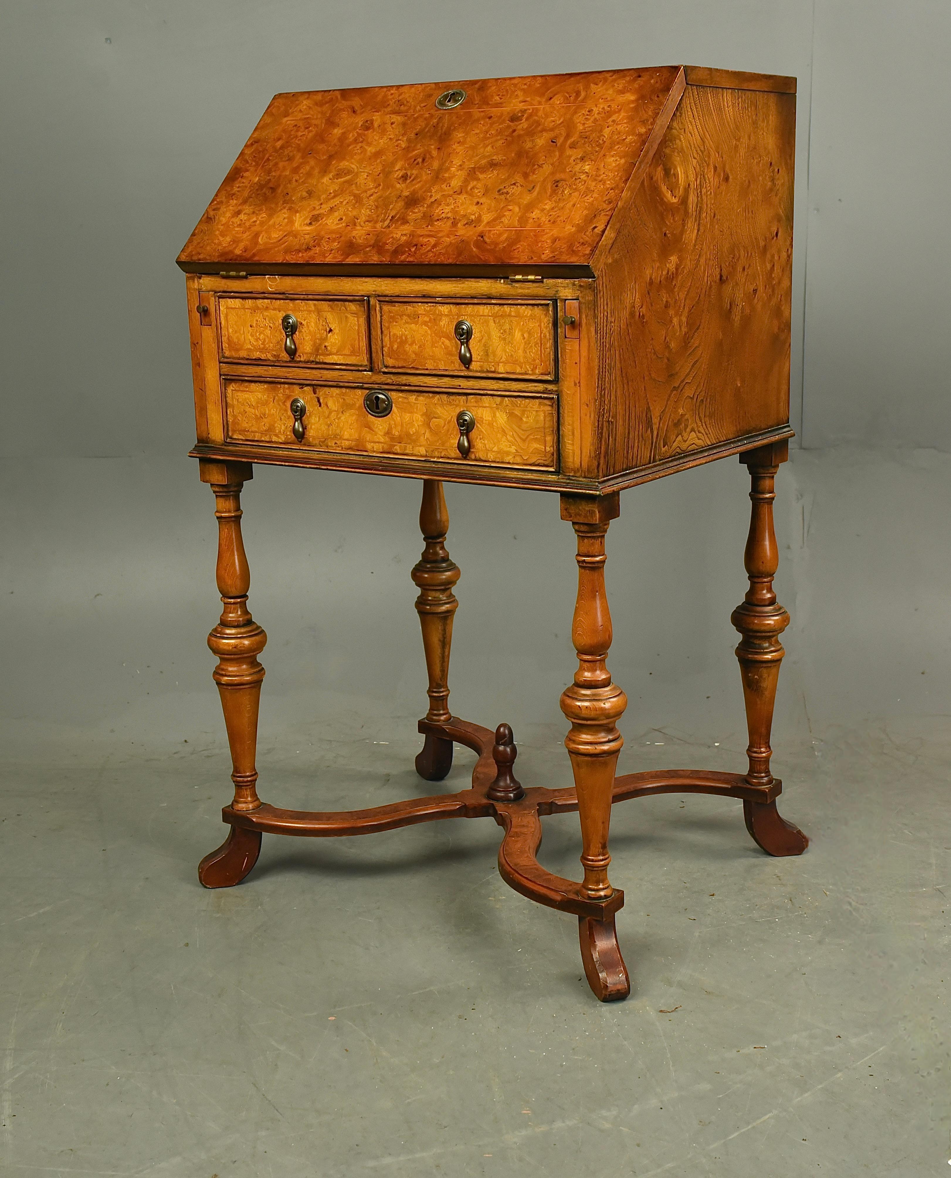 A good quality Queen Anne style walnut bureau .
A very well proportioned small size with a well fitted interior below there are three drawers ,the whole standing on turned legs united with a shaped stretcher .
There is a single key that fits all