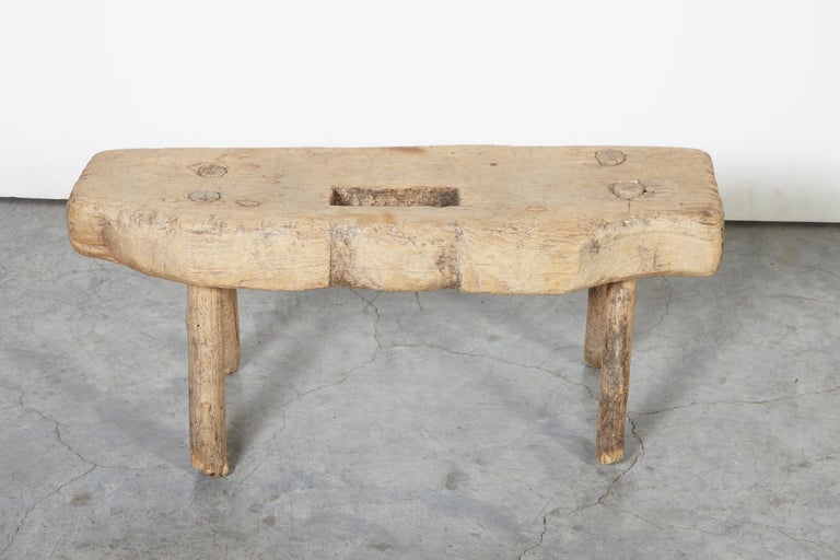 An adorable small, primitive and quirky wooden stool with a very thick top, irregular shape, great patina and simple short legs. This piece has so many uses, including display of preserves or spices in your kitchen. Just can't take your eyes off