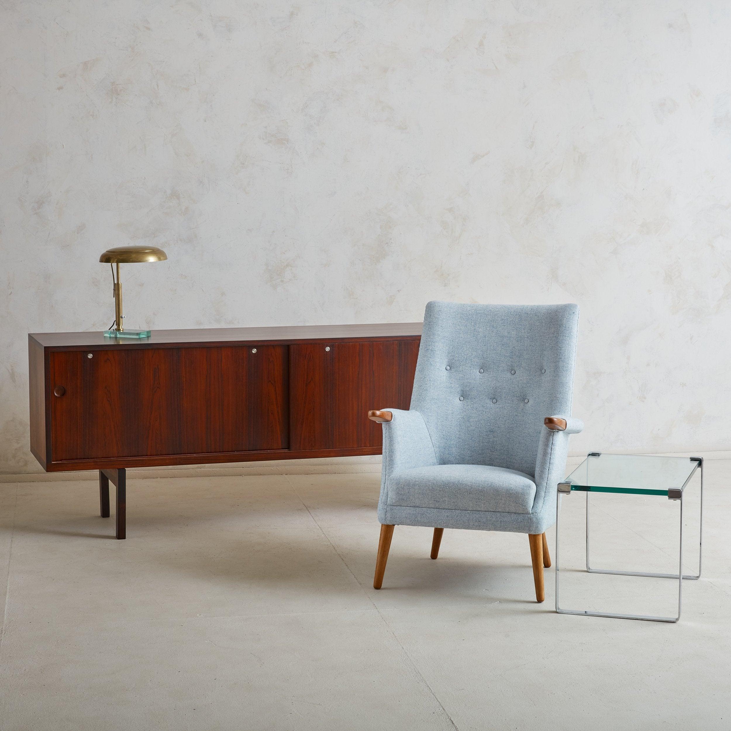 A Modern chrome and glass rectangular side table sourced in Denmark. This small side table features a minimalistic chrome frame and .75” thick aqua hued glass top. Denmark, 20th Century.

Condition: Great overall vintage condition. No significant