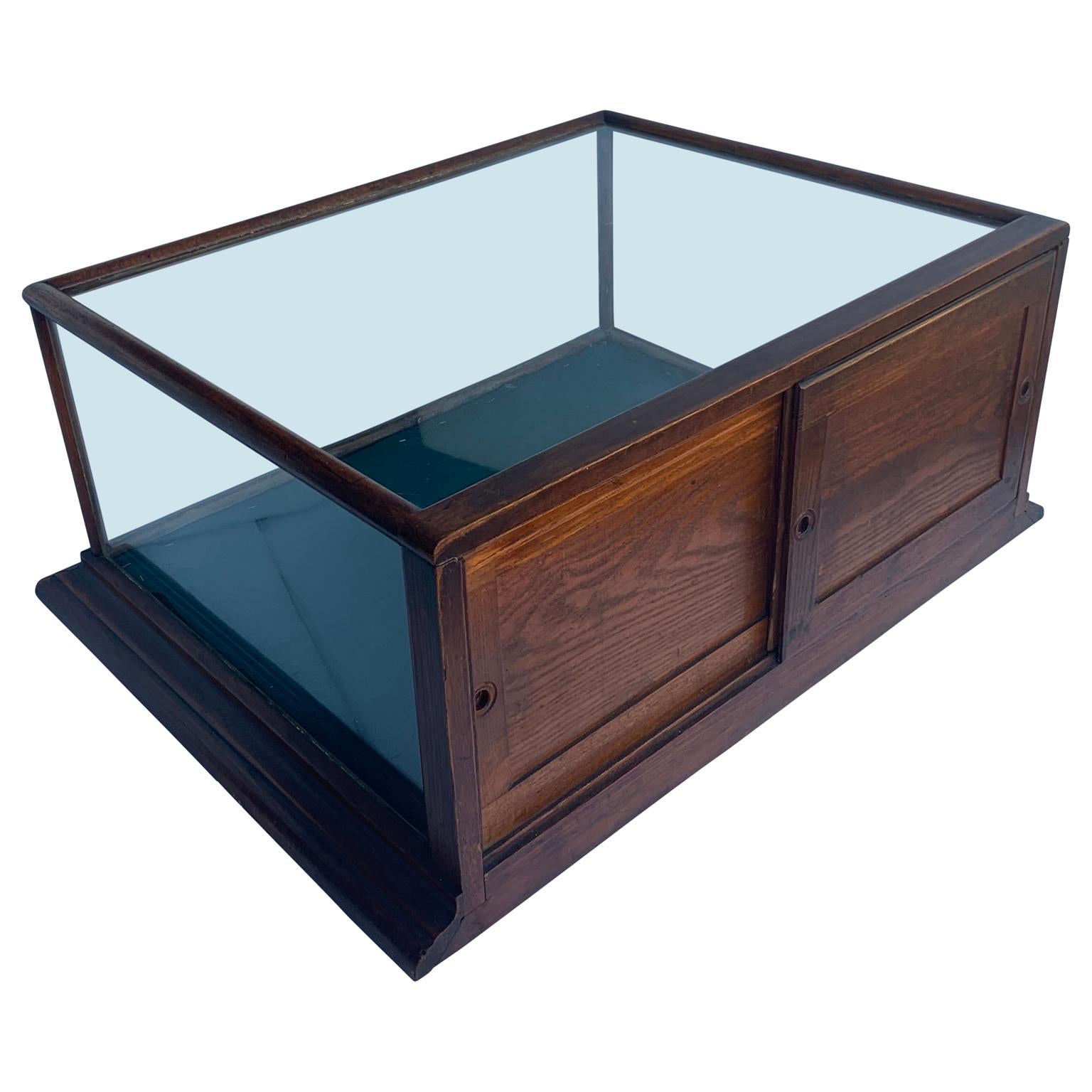 Small rectangular mahogany and glass table display cabinet

The two access doors have mirror-like on the inside.