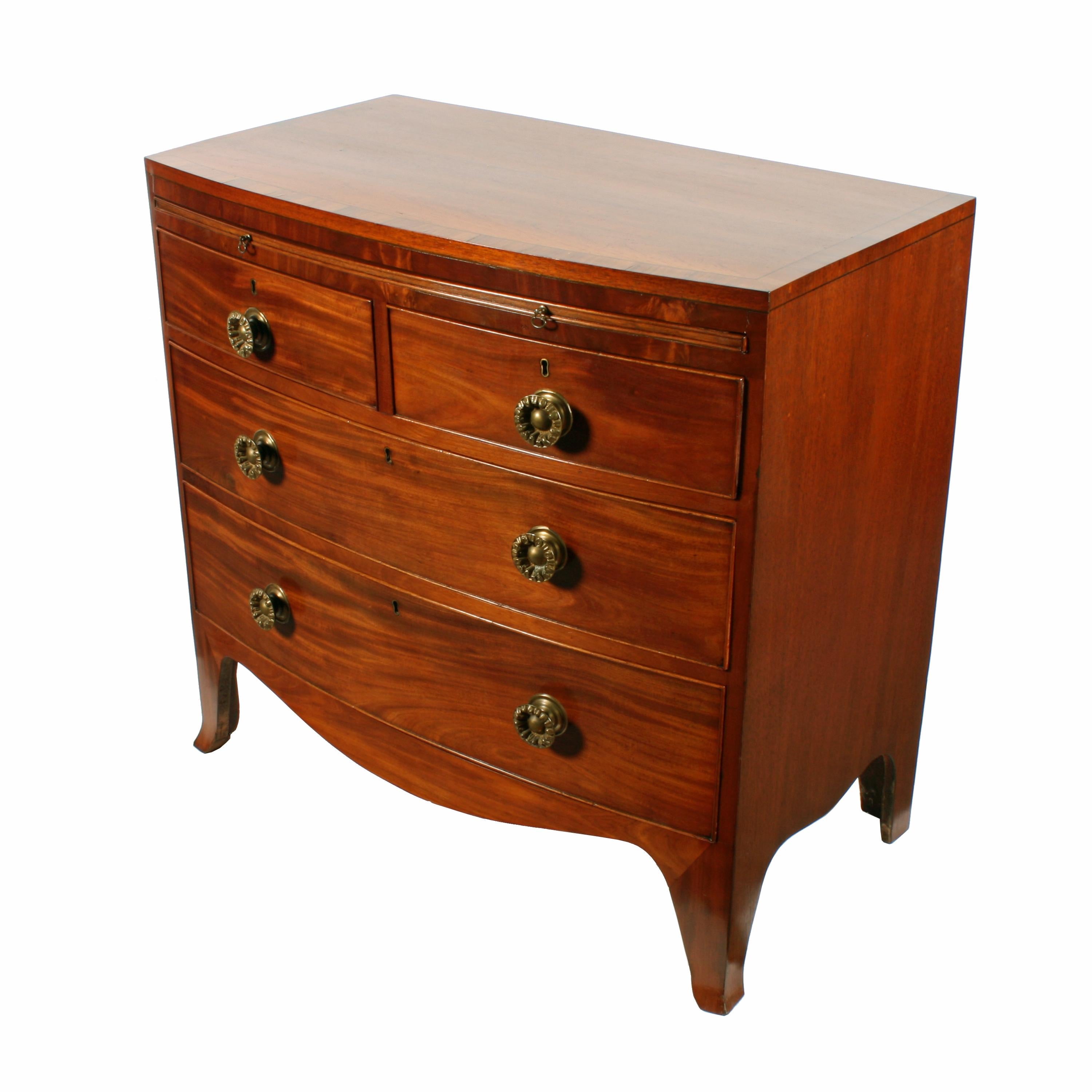 A small early 19th century Regency mahogany bow fronted four drawer chest.

The chest top has a broad rosewood crossbanded and ebony line inlaid edge.

The four drawers have a cock beaded edge and original brass knob handles.

The chest has a