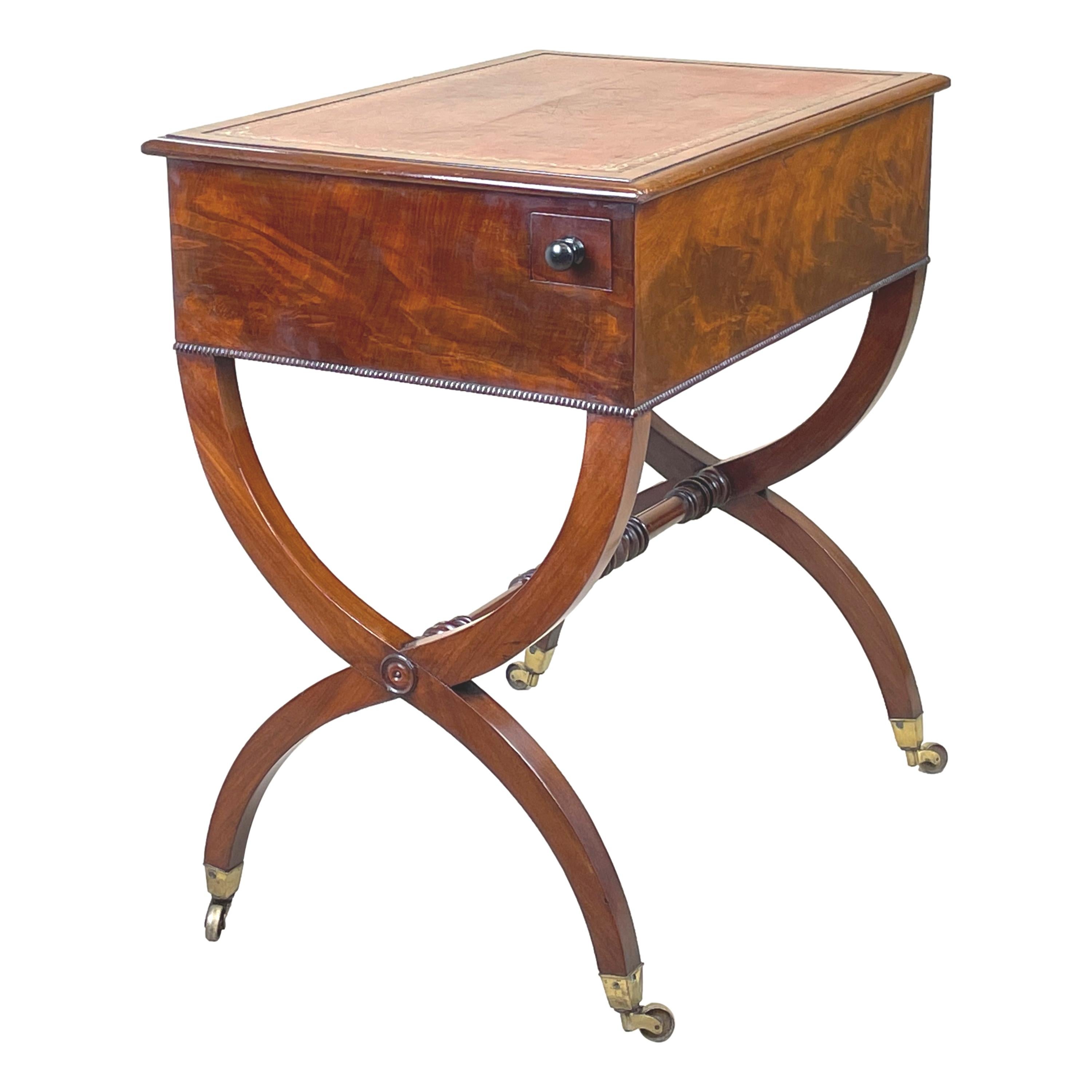 A fine quality regency period mahogany writing table
Having two fitted drawers to frieze with original
Turned knobs raised on elegant x framed end
Supports with original brass castors

(This charming little writing table oozes elegance
and class and