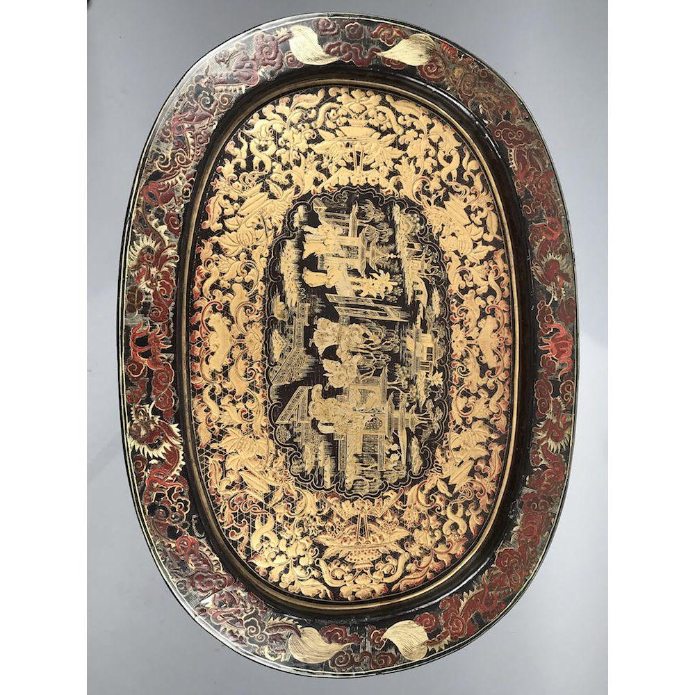 A Regency period polychrome chinoiserie-decorated oval papier mâché tray, on a bespoke ebonized and gilt stand.
Early 19th century, circa 1820. 

Papier mâché (papier mache) is a French term, literally meaning “paper – mashed up”; a material