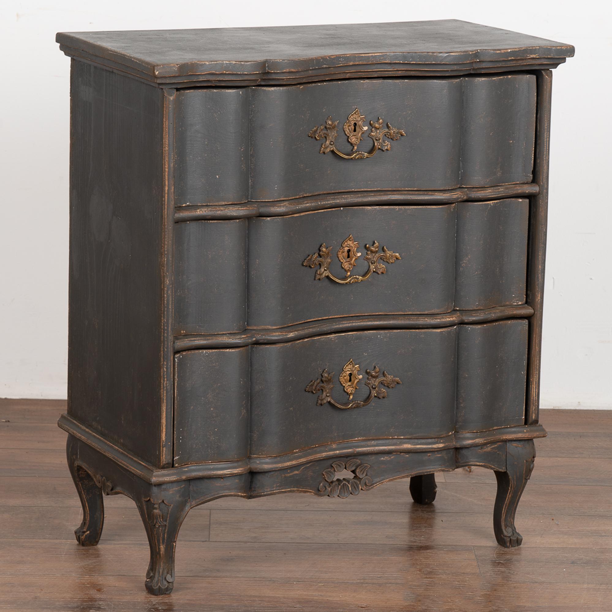 This small chest of three drawers has a touch of dramatic appeal thanks to the (newer) black painted finish that is gently distressed, accenting the Rococo curves and cabriole feet.
The size makes it adaptable to use as a nightstand, side table or