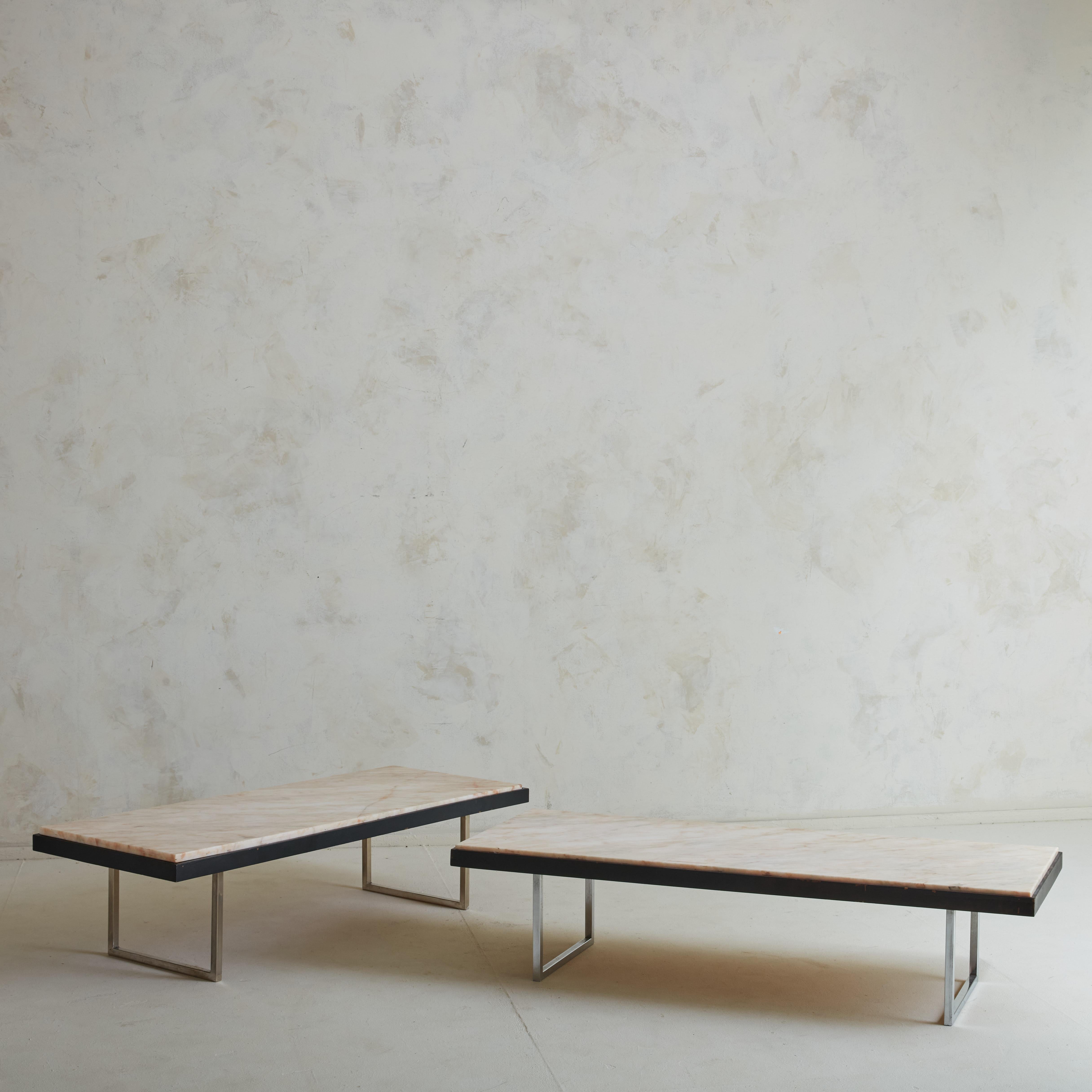 An elegant vintage coffee table featuring a  rare rosa aurora marble which has stunning pink veining throughout. The marble table top rests on a black wood frame and chrome legs. 

