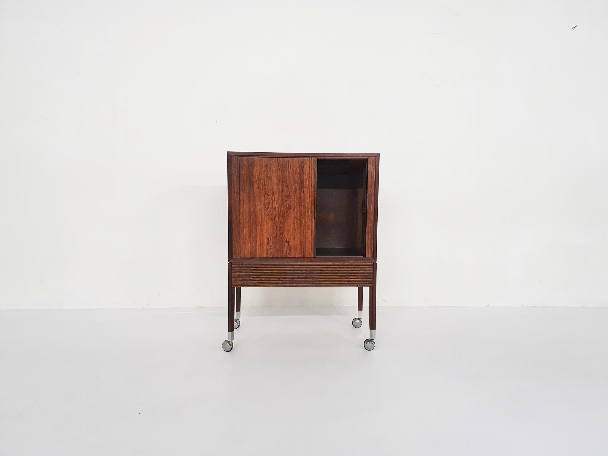 A audio cabinet on wheels which can also be used as a bar cart / serving trolley or as a nice cabinet for a small TV.

With very nicely made sliding doors. This cabinet was made by a talented furniture maker. Although it is marked, we haven't