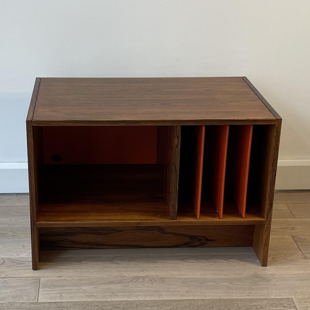 Storage cabinet in rosewood from the 1960's. This storage cabinet is all about functionality. It can be used to store magazines thanks to the boards that divide a single box into 4 distinct storage spaces. It can be used as a TV stand, in which you