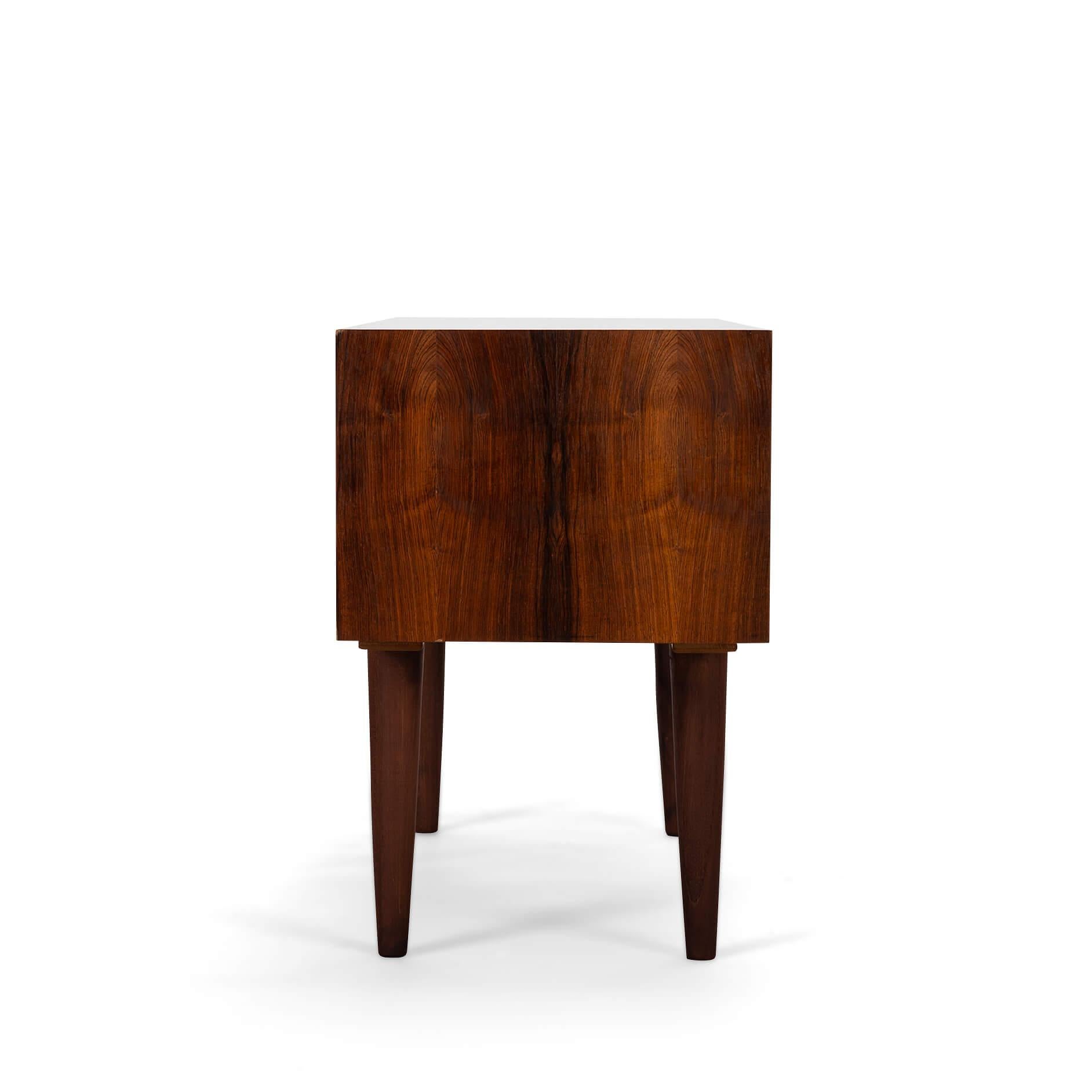 Danish Design by Kai Kristiansen This stylish chest of drawers was designed by Kai Kristiansen and produced by Feldballes Møbelfabrik in the 1960s. This cabinet is made of rosewood and has beautiful detailed lines with his signature eyelid handles,