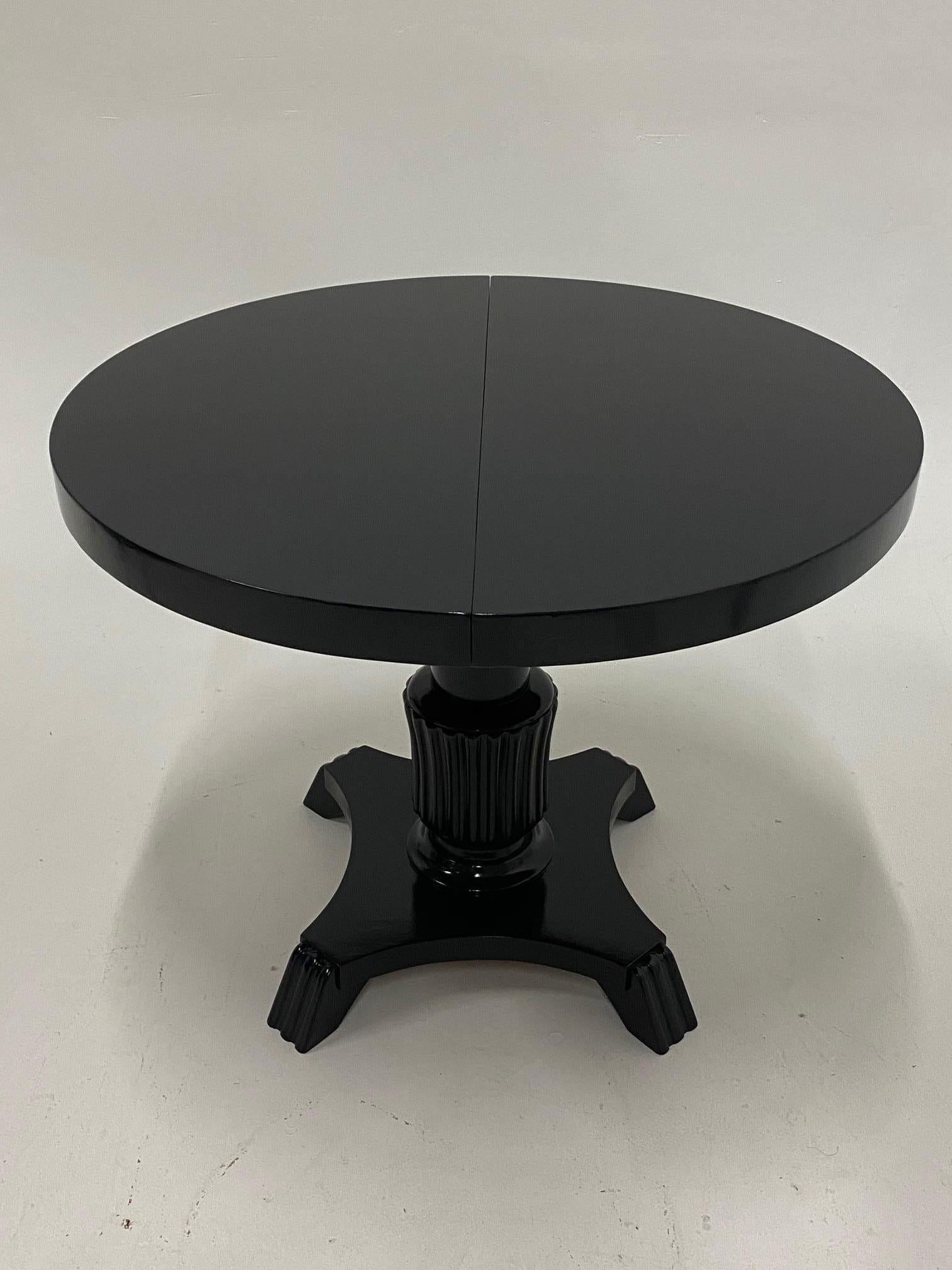 Chic very versatile dining table that is 35.5 diameter round when closed and has one leaf so when open the shape becomes oblong. Dimensions below. Table has a mechanism underneath to adjust height from 24