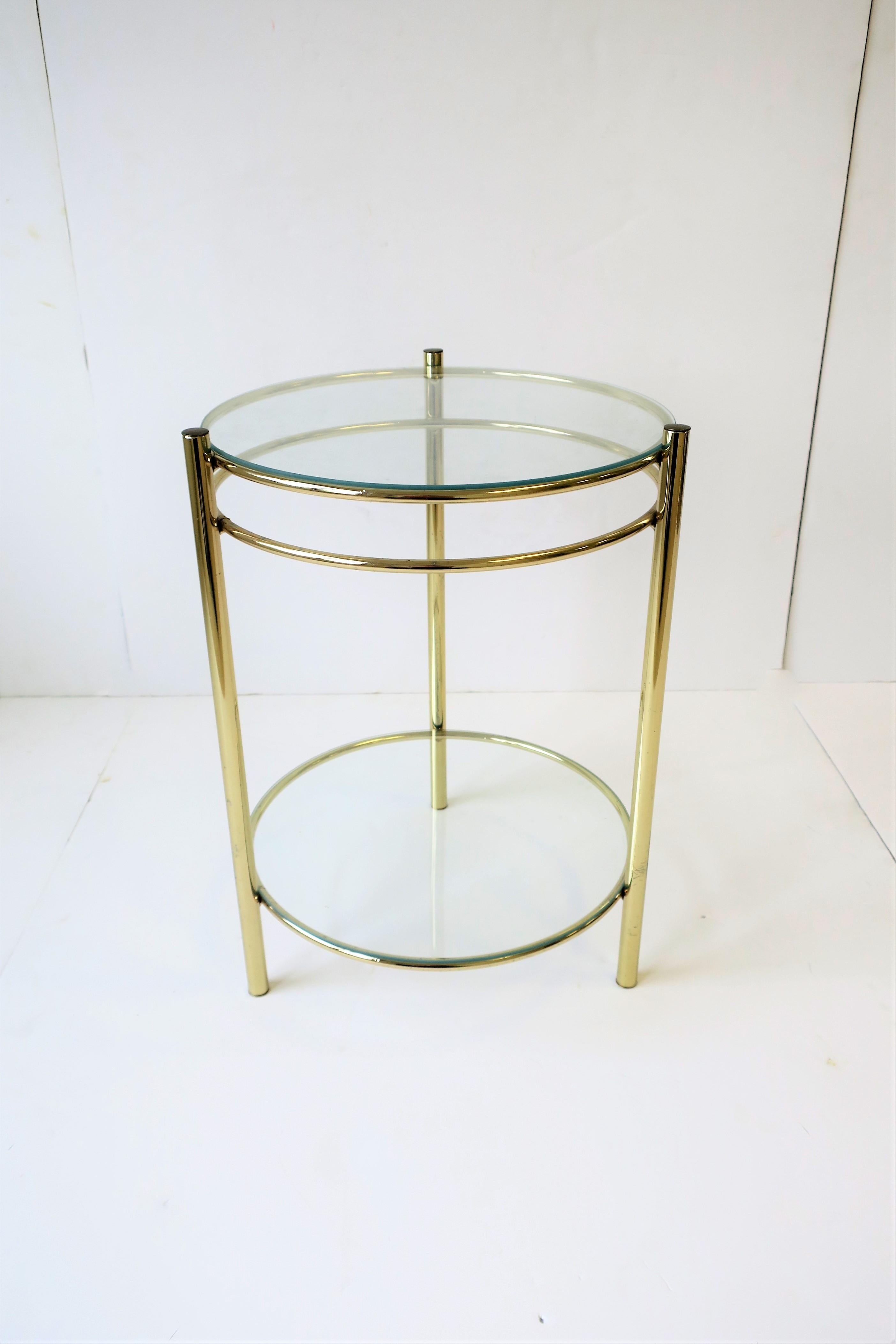 A small round brass plated metal and glass side or drinks table with lower shelf. Table is a convenient size measuring: 17