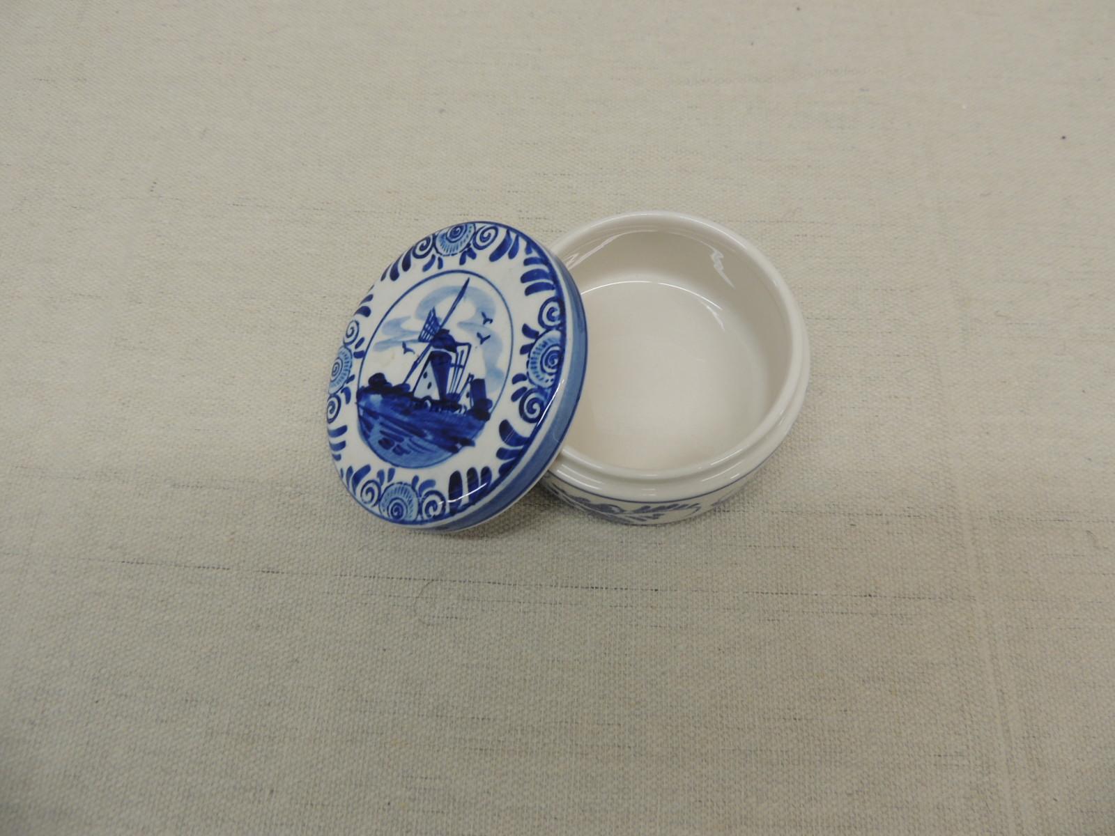 Small round delft blue and white trinket box with lid.
Delftware pottery.
Faience pottery.
Size: 3.25 x 1.75.
 