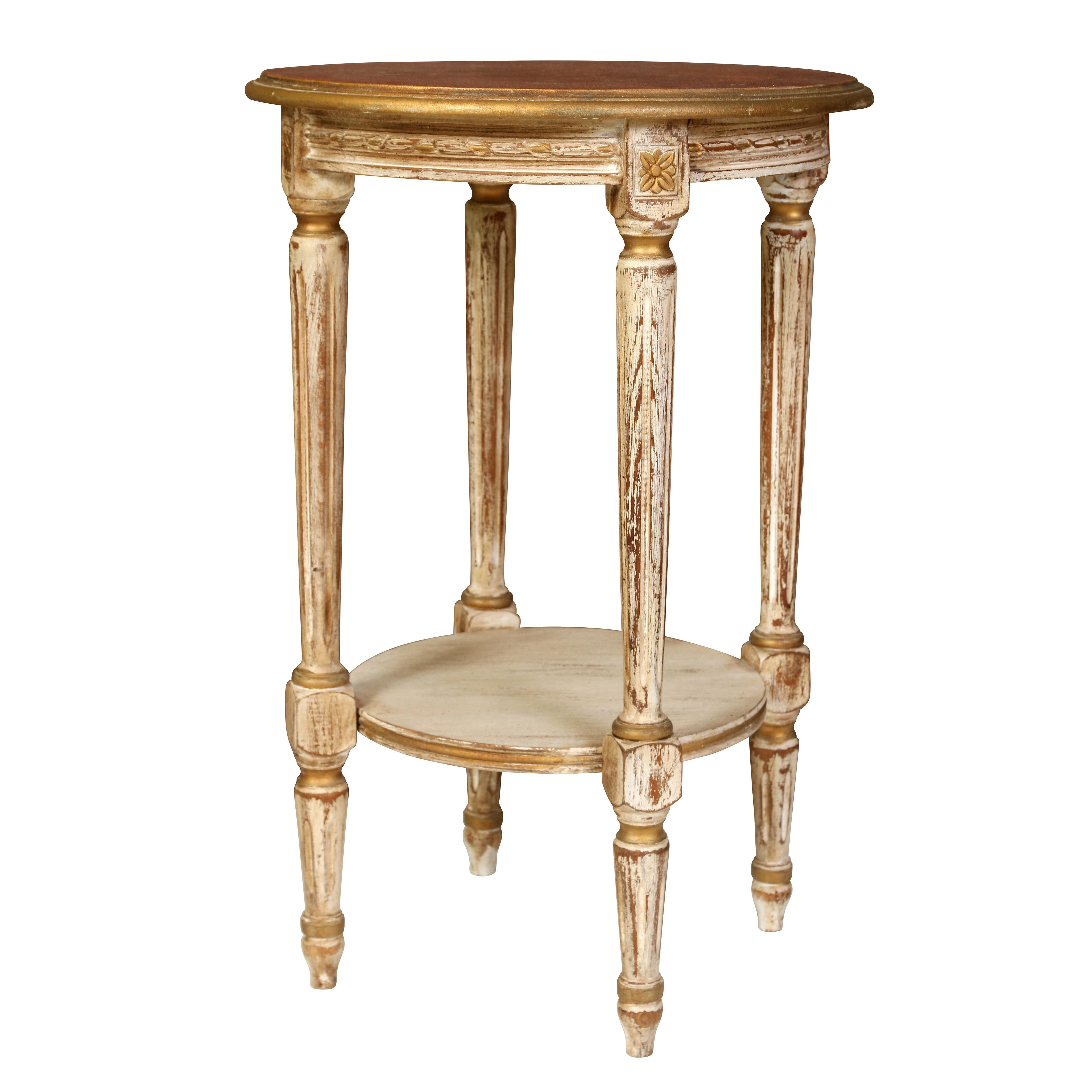 Every living room or family room needs a drinks table (if not several!)  This little one is oozing with character. The round top is stained wood accented with gold leaf around the rim.  The base is painted in a washed white with gold accents. 