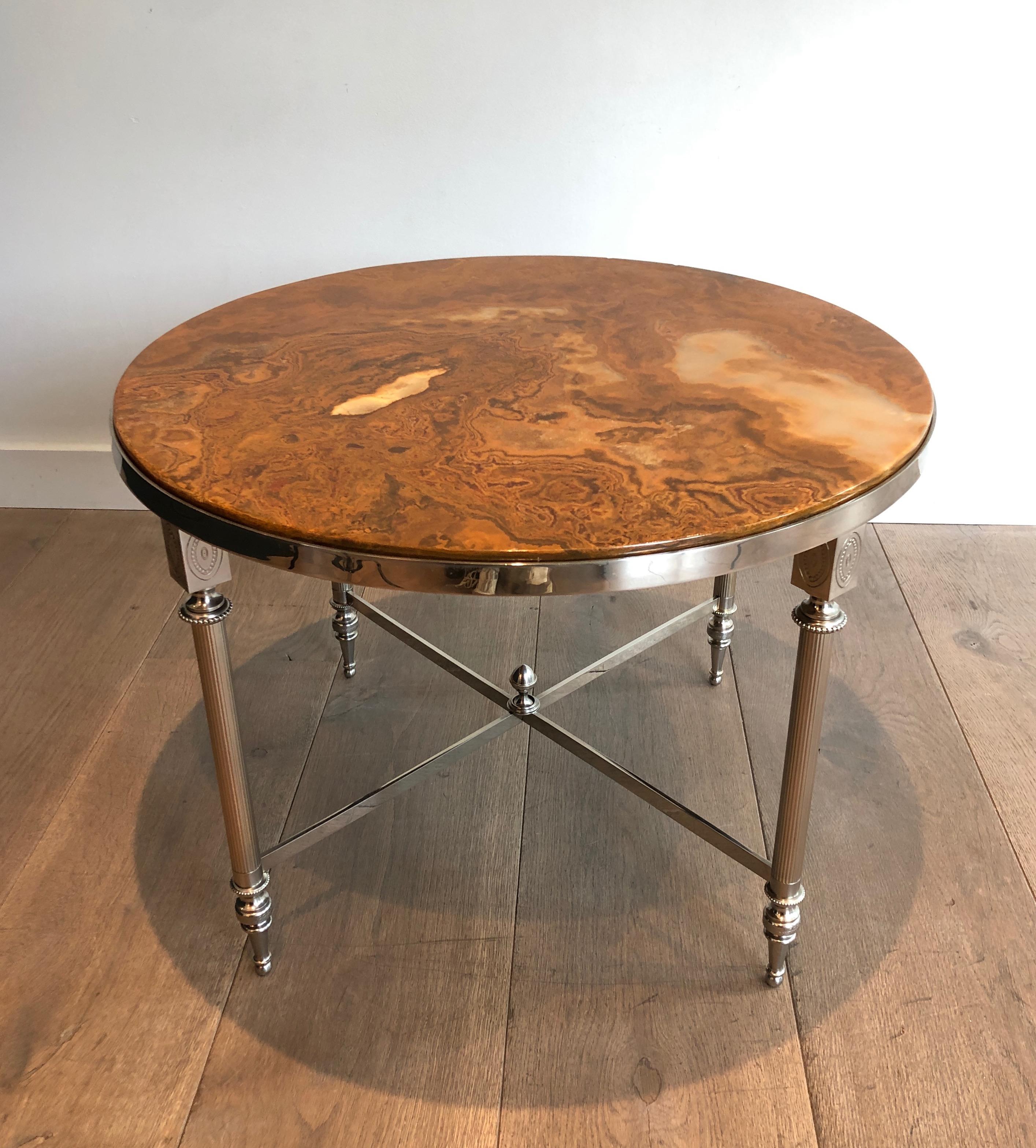 This round coffee table is silver plated with a beautiful onyx top. This is a French work in the style of Maison Jansen. Circa 1940.