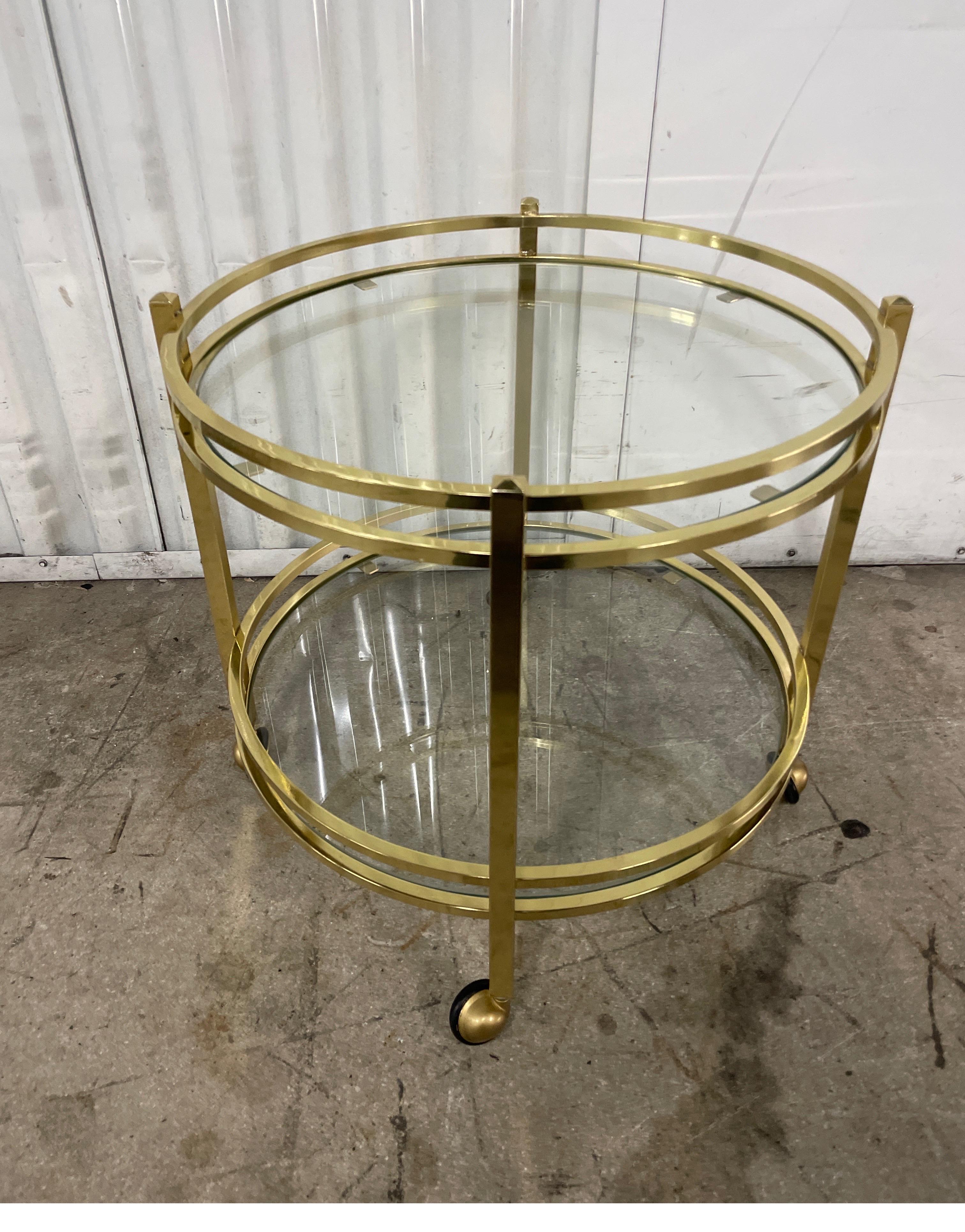 Sweet small two tiered Italian brass round cart on casters. Great little versatile piece with a multiple of uses. Perfect next to a chair as a drinks table. Also, a great bar cart for that small nook.