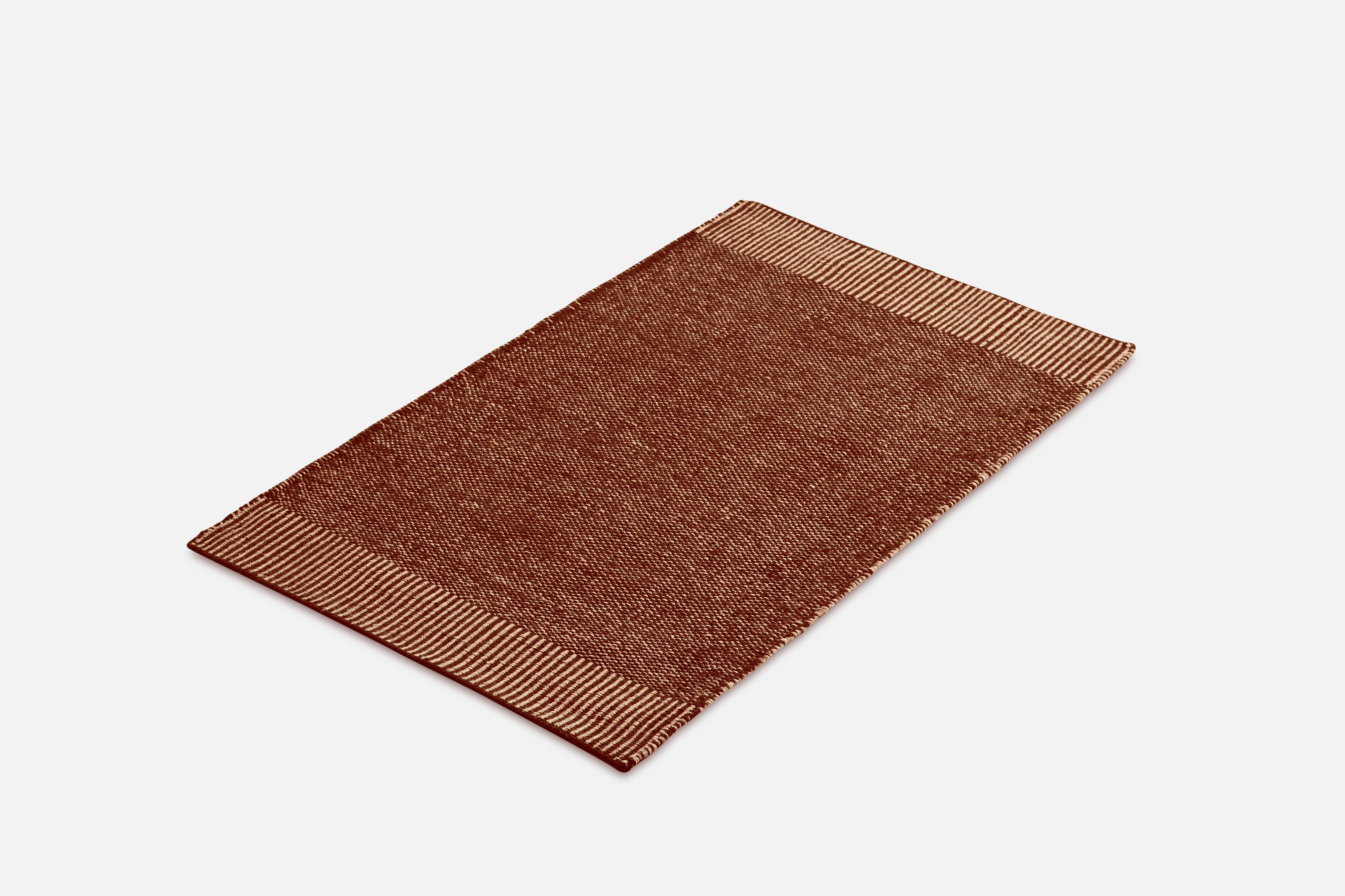 Small rust Rombo rug by Studio MLR
Materials: 65% wool, 35% jute.
Dimensions: W 90 x L 140 cm
Available in 3 sizes: W90 x L140, W170 x L240, W75 x L200 cm.
Available in grey, moss green and rust.

Rombo is characterised by the materials used