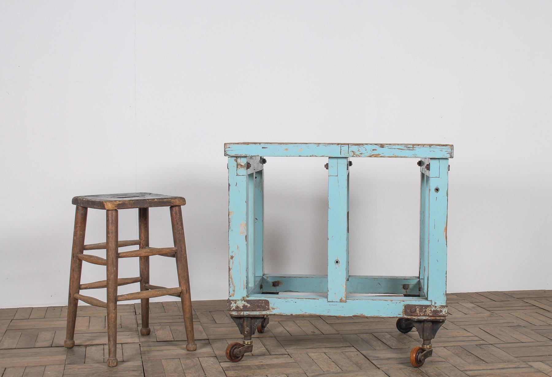 Introducing this charming small industrial bakery table, a perfect blend of functionality and vintage appeal. Finished in a beautiful duck egg blue paint with a heavily worn patina, this table serves as both a decorative piece and a practical
