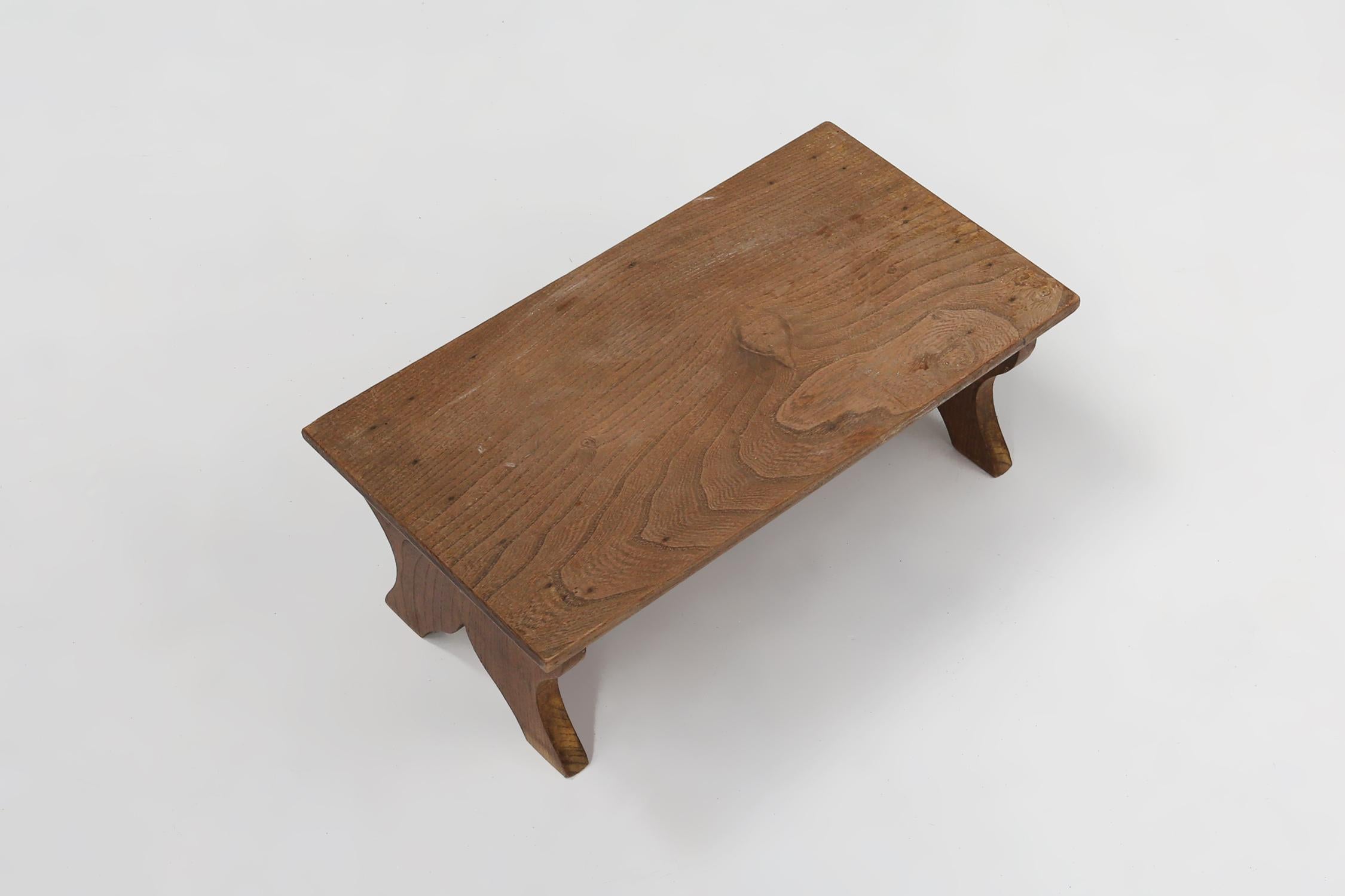 French Small rustic wooden stool with curved base, France ca. 1900 For Sale