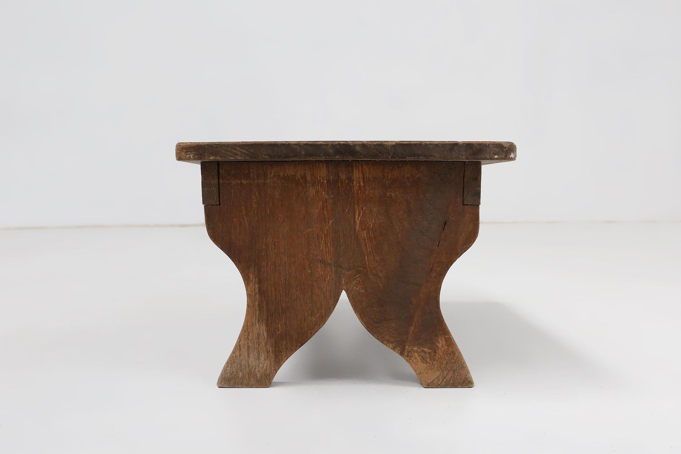 Wood Small rustic wooden stool with curved base, France ca. 1900 For Sale