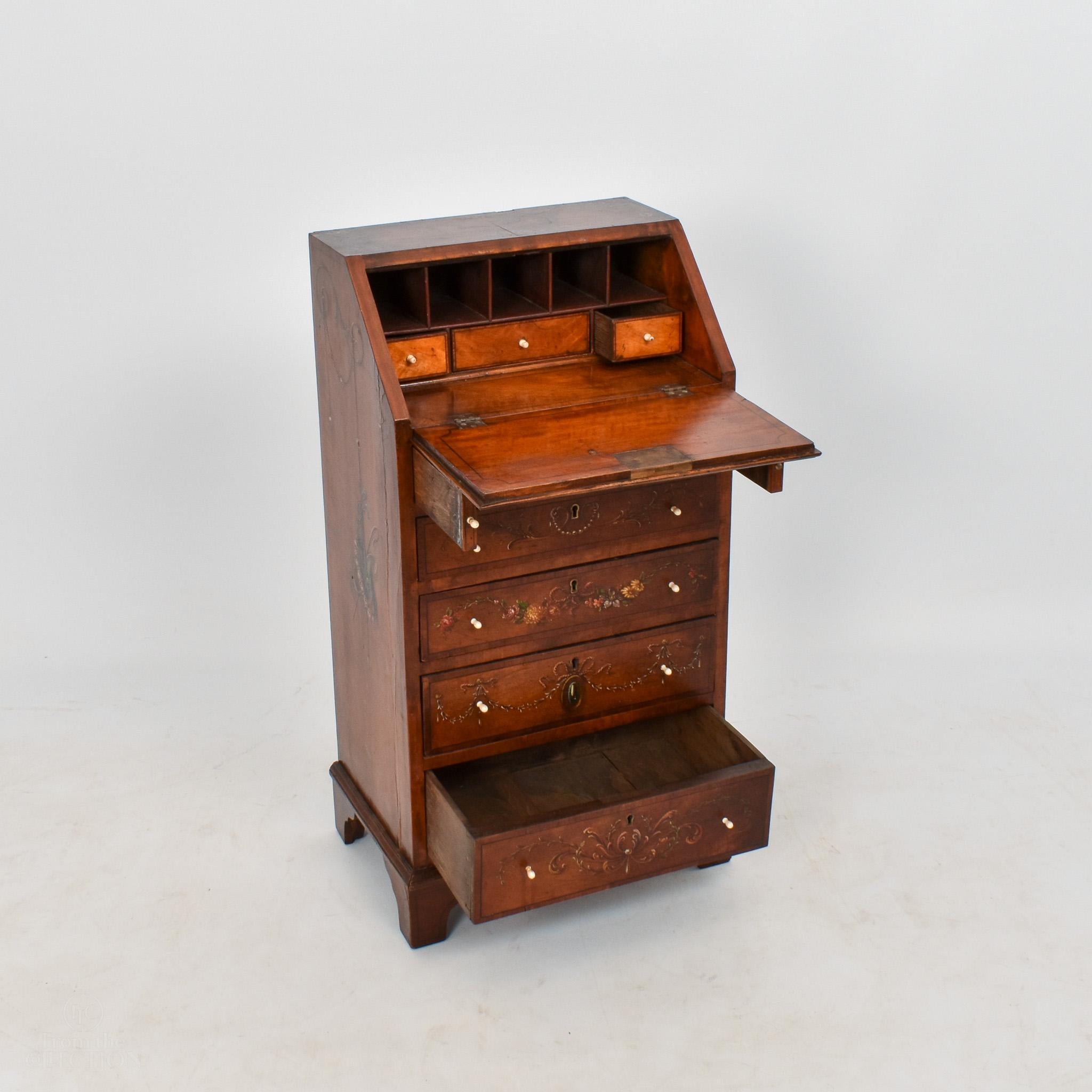 This small satinwood bureau desk circa 1770 is only 75cm tall, making it a very unique piece. It is of the George II / III period with beautifully original painted decoration of garlands of flowers and a miniature portrait to the centre of the top,