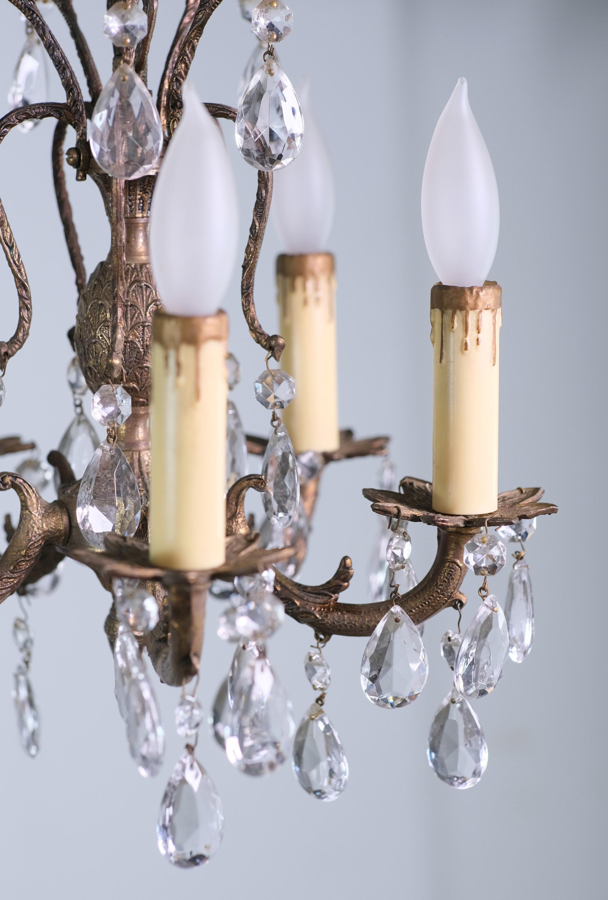 Beautiful small scale ornate bronze chandelier don in a French style. Dripping with crystals and done with floral details. Uses five candelabra light bulbs. This can be seen at our 400 Gilligan St location in Scranton, PA.