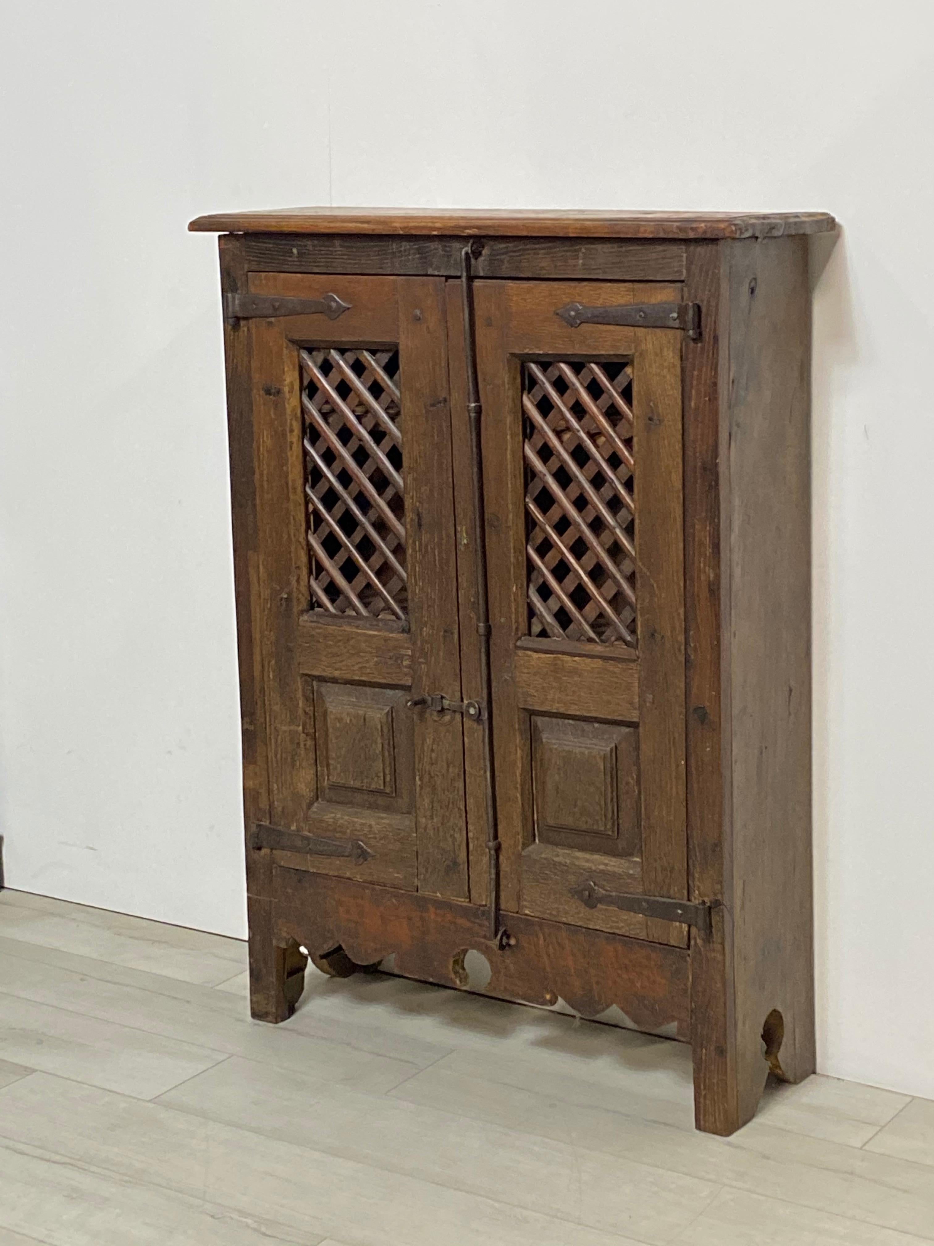 Highly unusual, small-scale Latin American (possibly Mexican), late 18th/early 19th century Mesquite wood two-door cabinet. This is approximately 1/4 size of the usual cabinets of this type. It was likely used for food storage. It has all original,