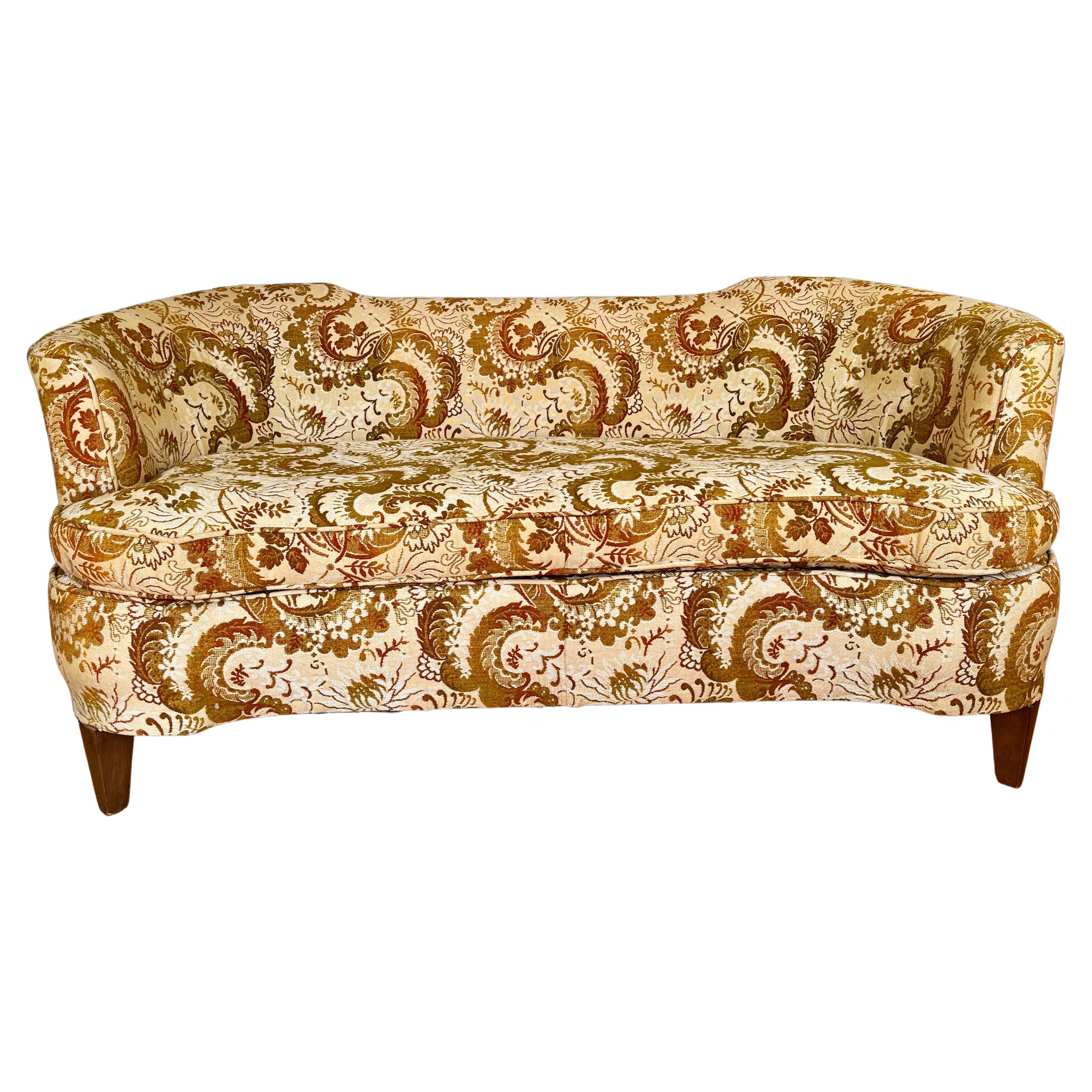 A small scale curved notched back modern style sofa with distinct design elements as seen in the Adelina sofa; Edward Wormley for Dunbar at Baker. Features : Floral Damask upholstery and single loose cushion. Of heirloom quality the sofa possesses