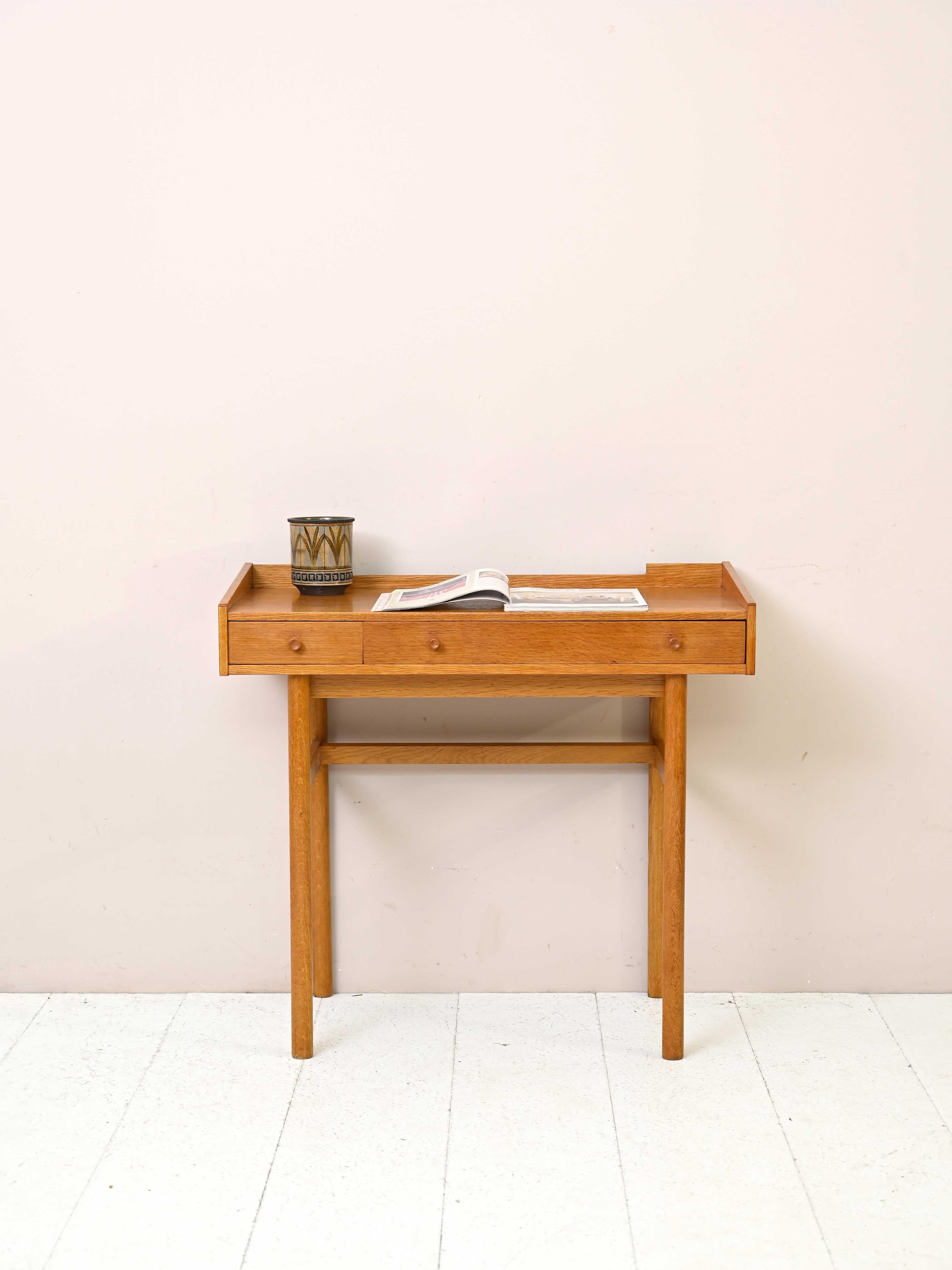 Swedish vintage oak desk with drawers.

This small-sized desk is perfect for recreating a small study corner in the home.
The simple lines and light color of the oak wood make it a modern piece of furniture that will enrich your home in an