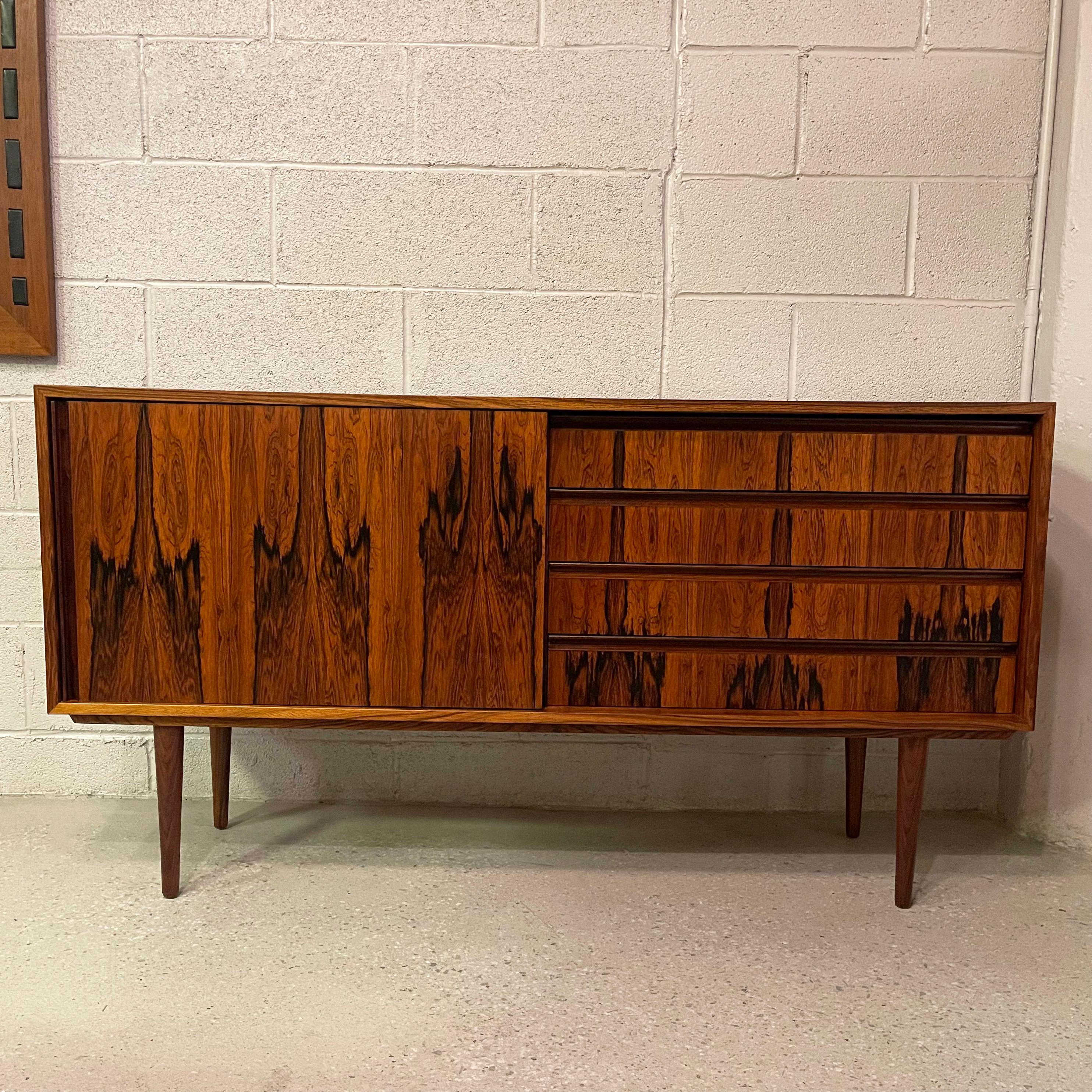 Streamlined, Scandinavian modern, Brazilian rosewood credenza features a gorgeous grain with sliding door on one side and drawers on the other. It's small size at 55.5 inches wide x 15.75 inches deep makes it the perfect apartment size, mid-century