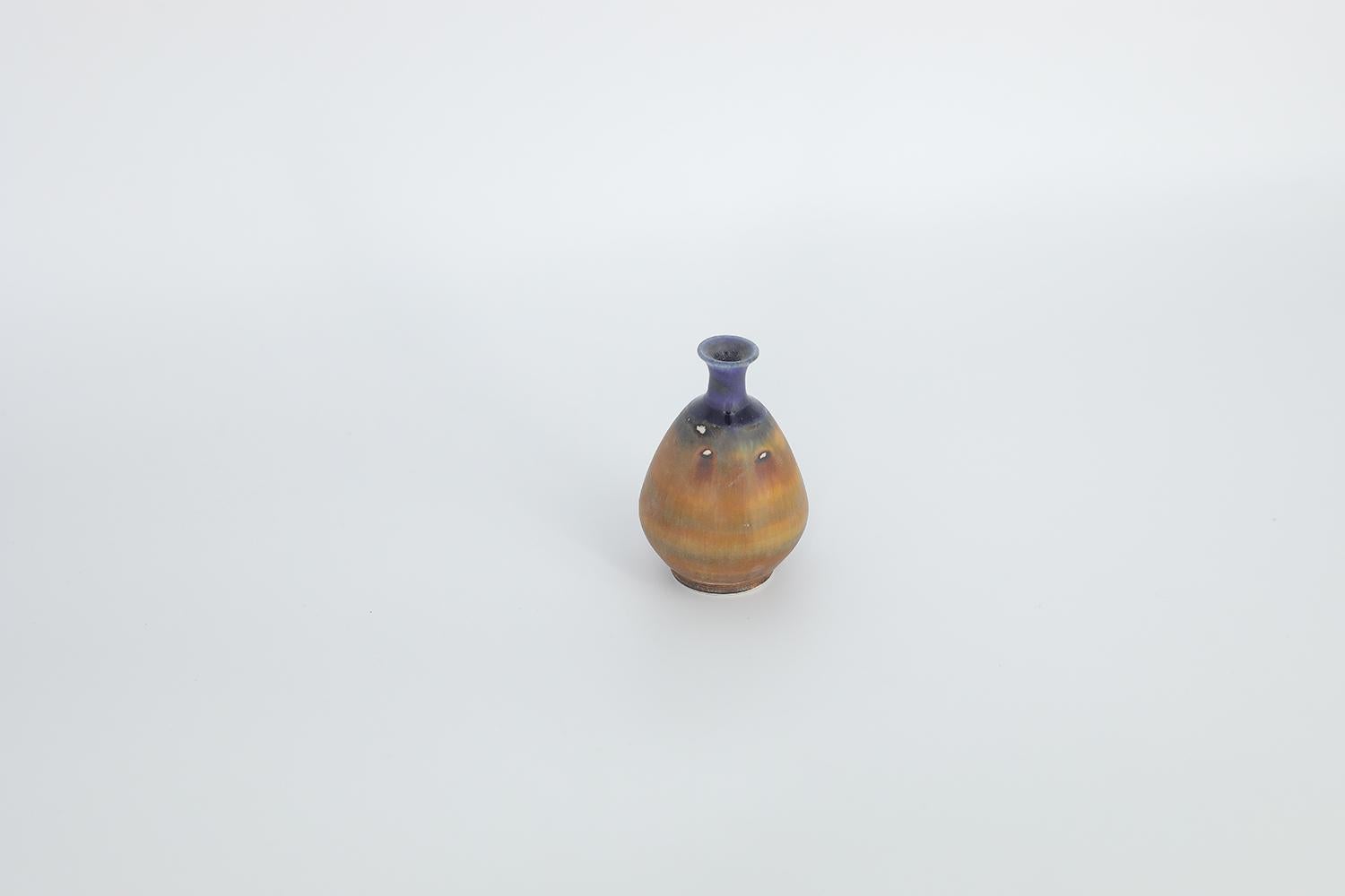 This miniature, collectible stoneware vase was designed by Gunnar Borg for the Swedish manufacture Höganäs Keramik during the 1960s. Handmade by a Master, with the utmost care and attention to details. The vase is dyed in blue and brown, in an