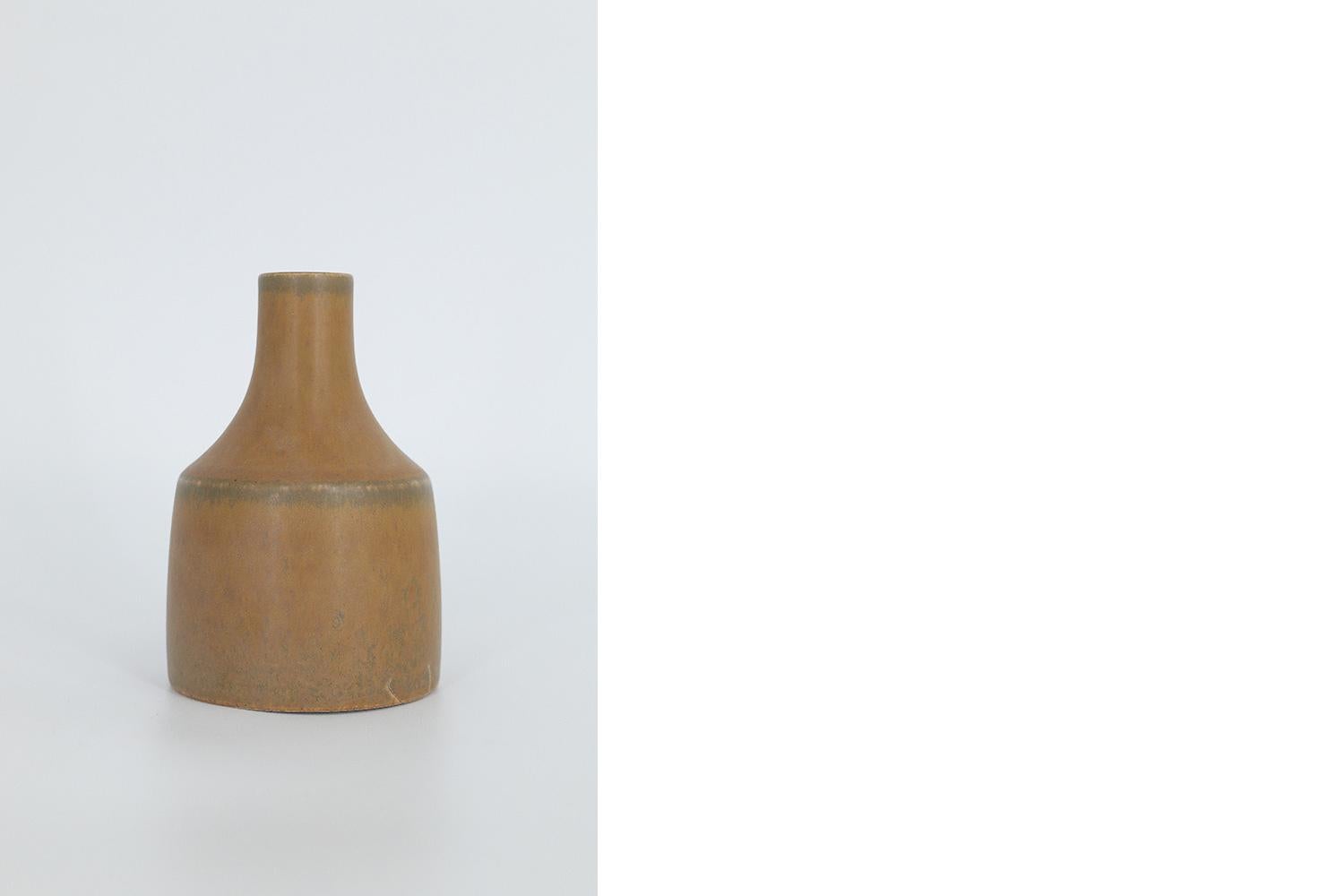 This miniature, collectible stoneware vase was designed by Gunnar Borg for the Swedish manufacture Höganäs Keramik during the 1960s. Handmade by a Master, with the utmost care and attention to details. The caramel colored vase with an irregular