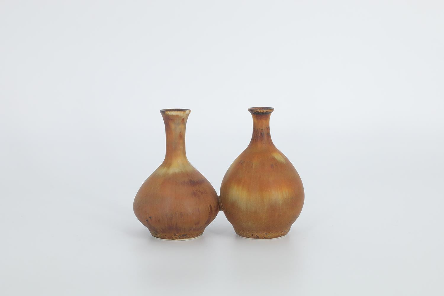This miniature, collectible stoneware vase was designed by Gunnar Borg for the Swedish manufacture Höganäs Keramik during the 1960s. Handmade by a Master, with the utmost care and attention to details. Two vases forming a unity, colored in an