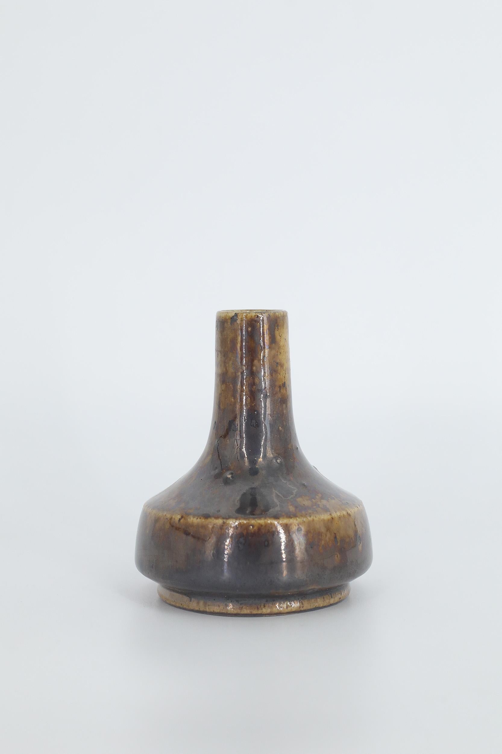This miniature, collectible stoneware vase was designed by Gunnar Borg for the Swedish manufacture Höganäs Keramik during the 1960s. Handmade by a Master, with the utmost care and attention to details. The brown-colored vase with an irregular shade.