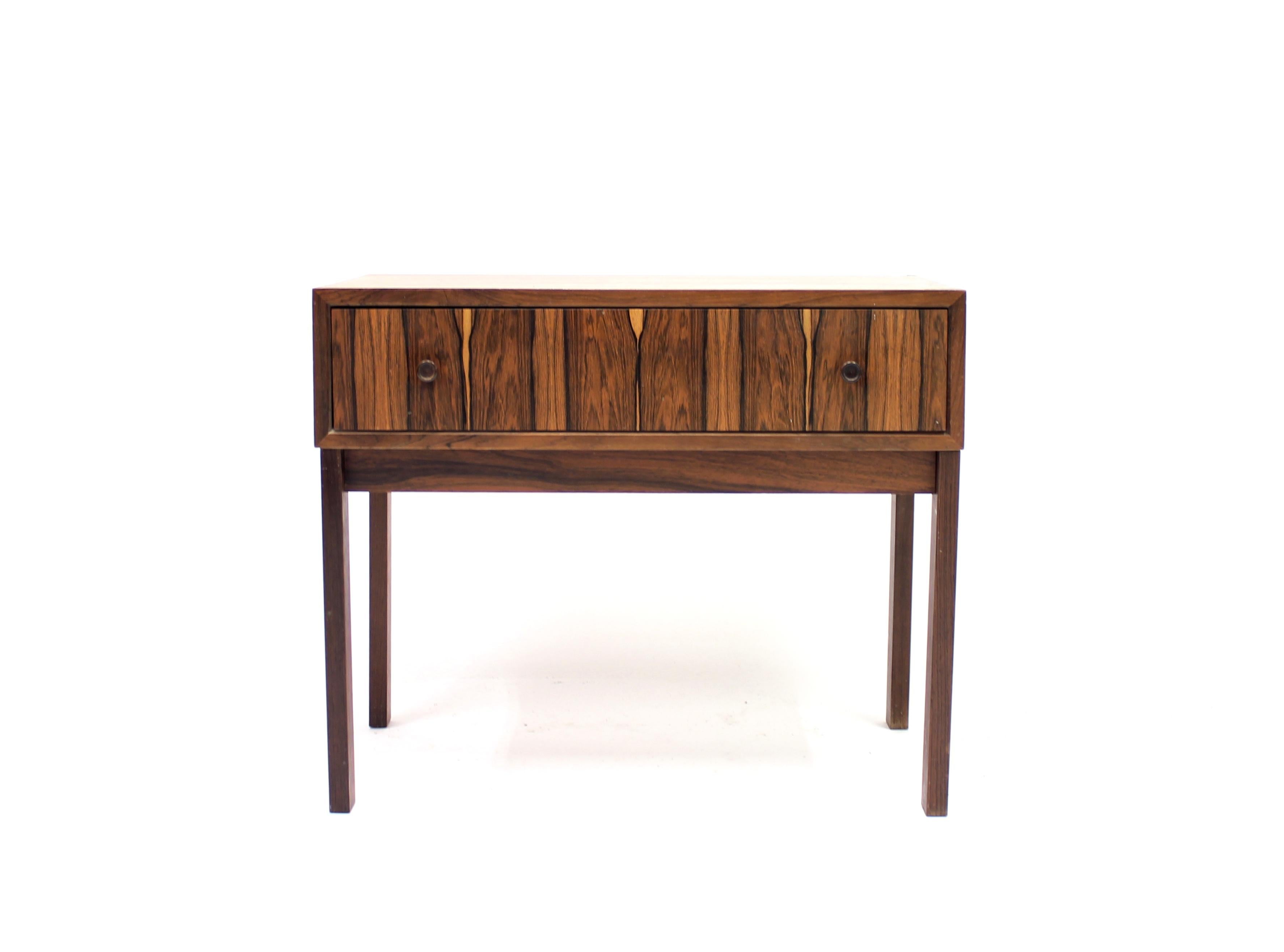 Small rosewood single drawer chest of drawers or nightstand of Scandinavian origin. Made in the 1960s.