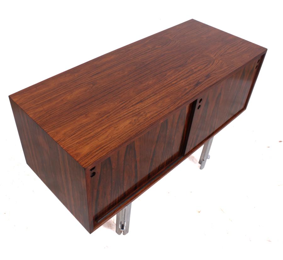 Small Scandinavian rosewood sideboard, circa 1960.
A small unusual rosewood sideboard with chrome legs and two sliding drawers with adjustable drawers behind the rosewood had been re finished and there two scratches that couldn't be polished out to