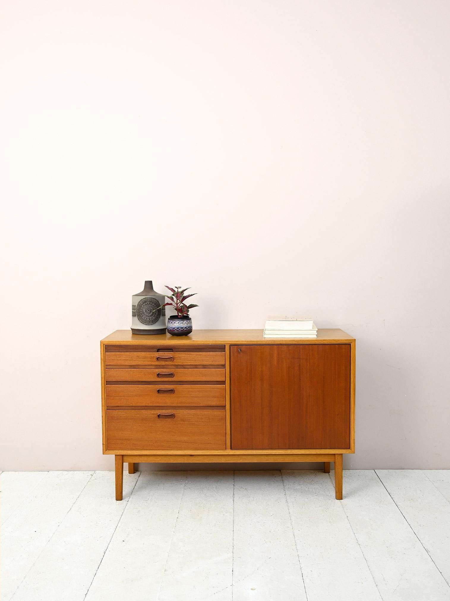 Vintage 1960s cabinet with drawers and storage compartment.

A beautiful and functional piece of furniture that can be placed in different rooms of the house and serve as a smart working station when needed.
Consisting of a teak and oak frame,