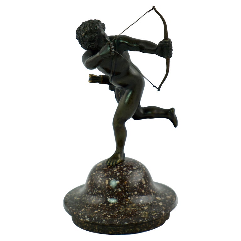 Small Sculpture of a Putti "Amour" with a Porphyry Base For Sale