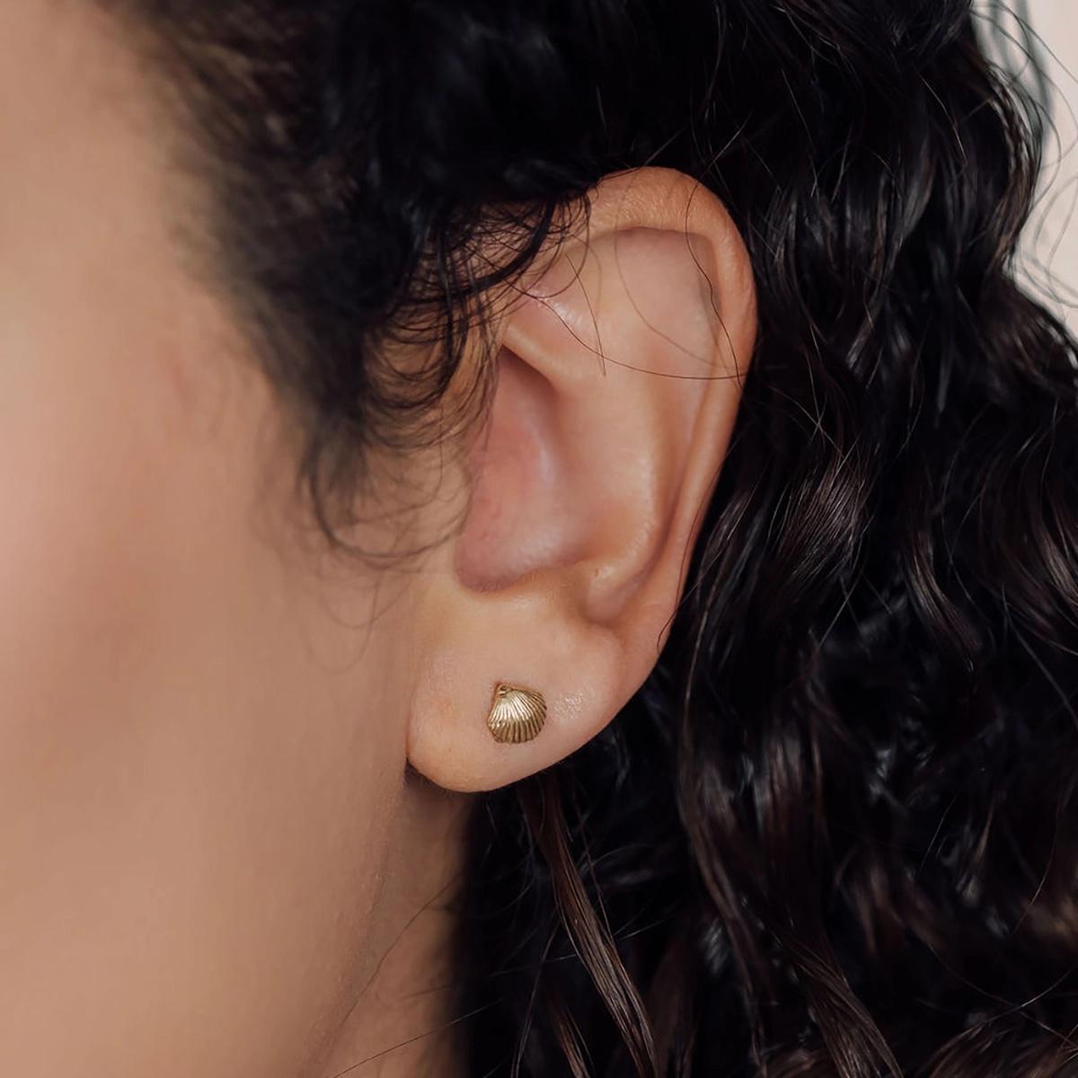 Transform the ordinary into extraordinary with these petite seashell studs, expertly crafted in 14k gold with intricate detail.
Capturing the essence of nature's artistry, each curve and contour beautifully mimics the delicate intricacies of natural